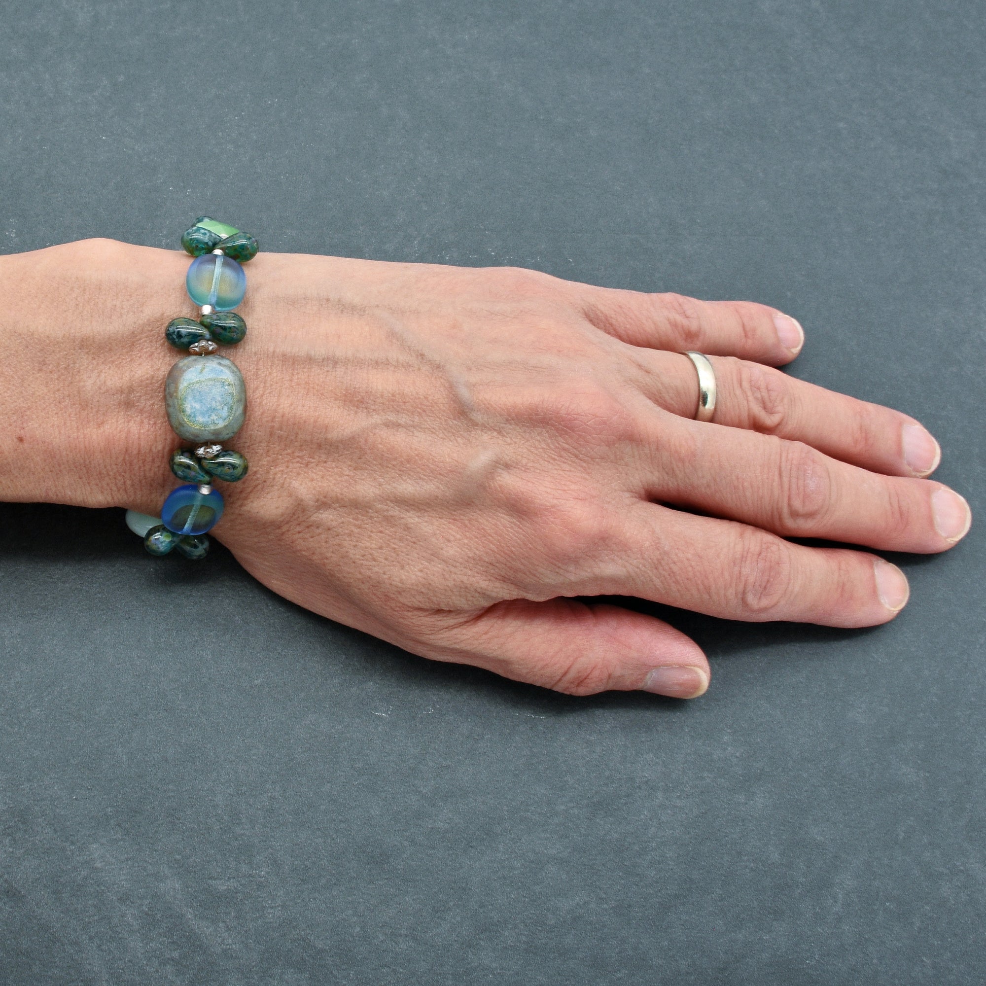 The jewelry shown in the image is a bracelet. It is worn around the wrist and features beads of various colors and shapes.