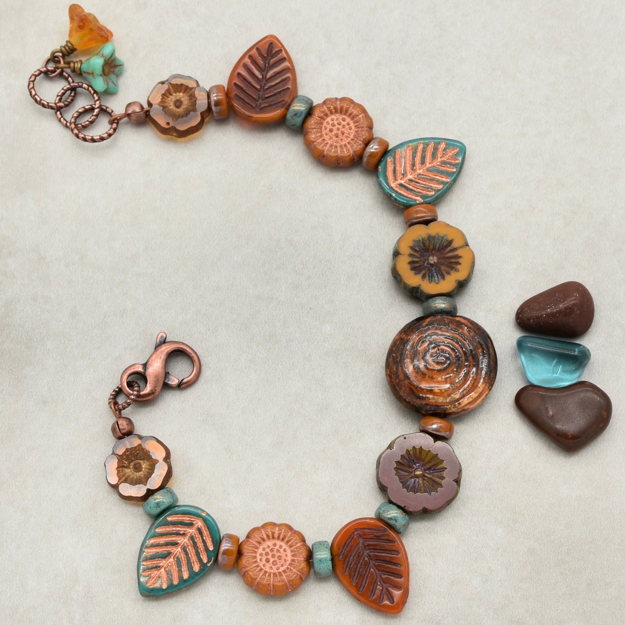 This image shows a bracelet. The jewelry piece is circular and has a clasp, typical of bracelets. The beads and charms are spaced around the circle, which is characteristic of a bracelet design.