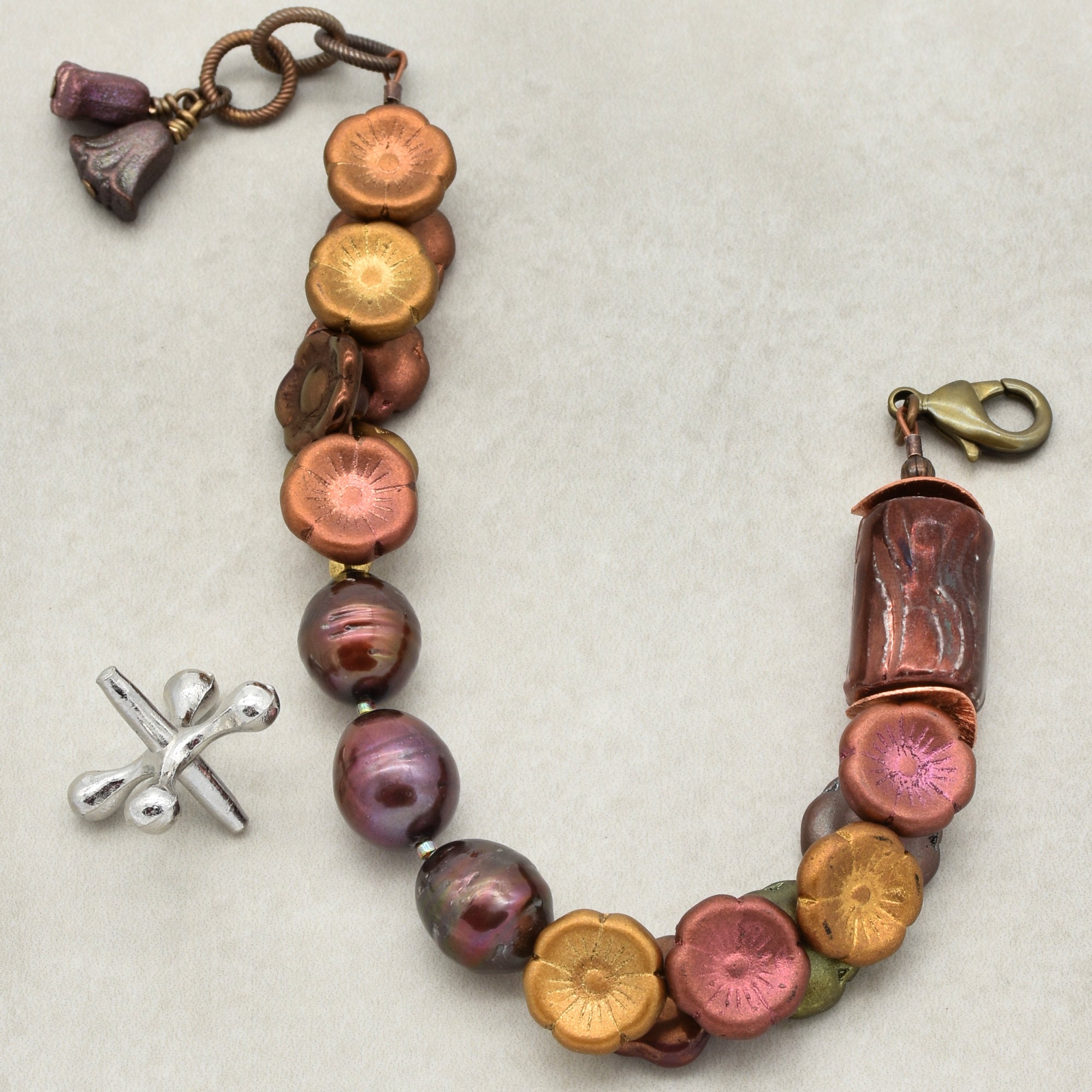 Multicolored beaded bracelet with charms on a light background