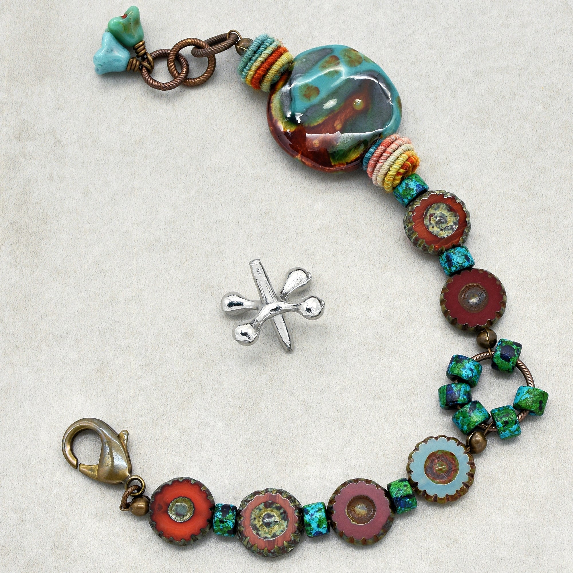 This image shows a bracelet. The size and design, including the clasp and the way the elements are arranged in a short circular form, are typical characteristics of a bracelet.