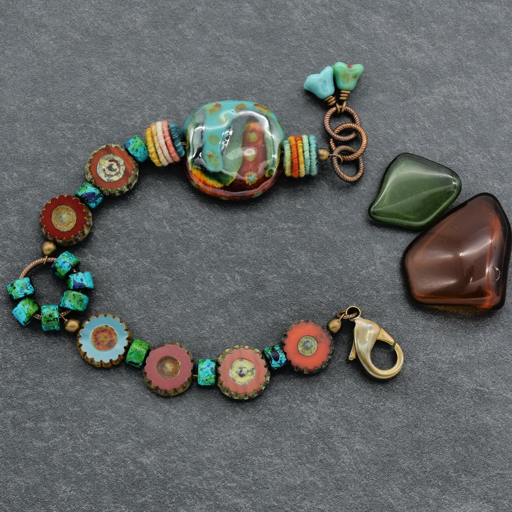 This image shows a bracelet. The size, shape, and clasp type are consistent with bracelets, and the decorative beads and elements are arranged in a way typical for bracelet designs.