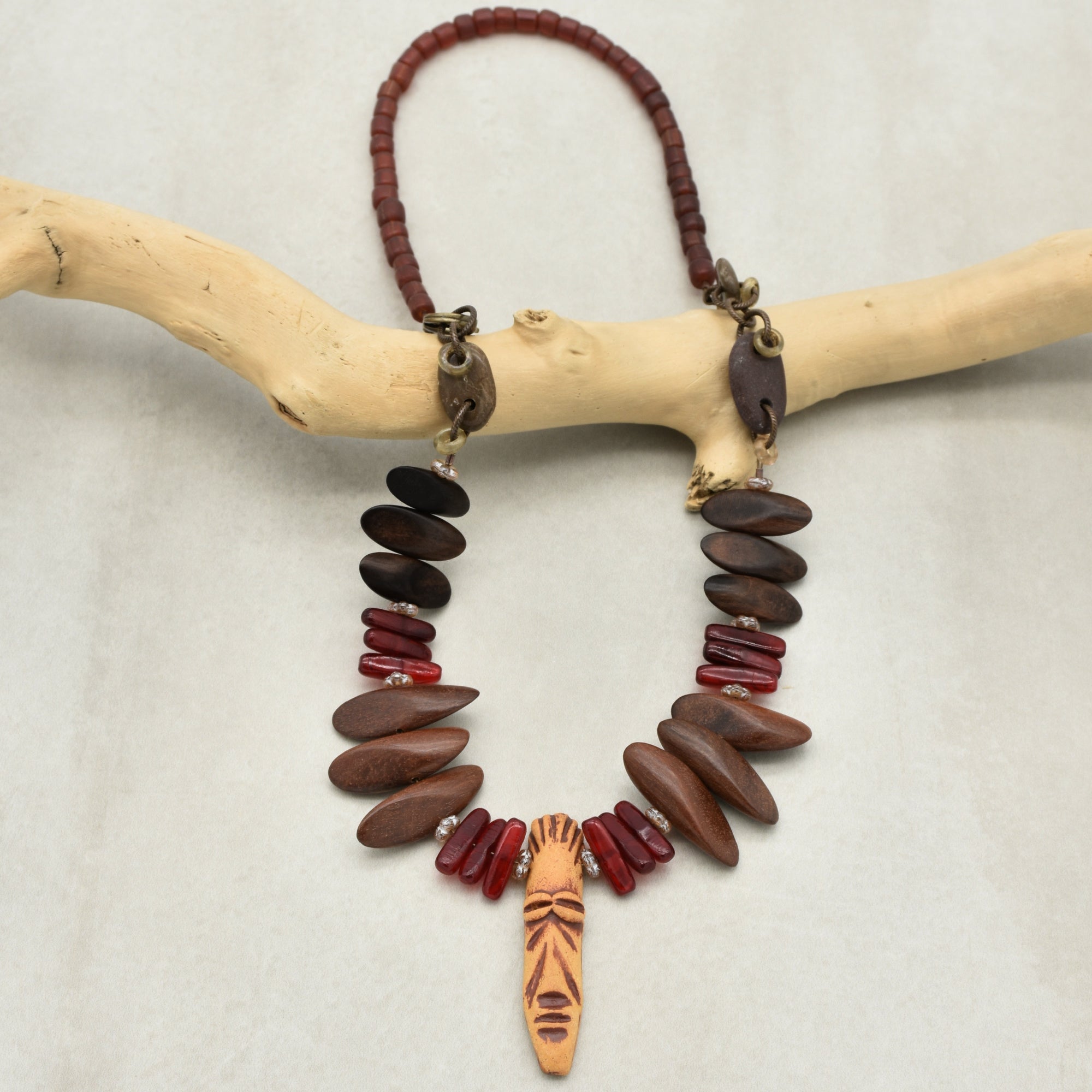 This jewelry piece is a necklace. It has a string of beads and decorative elements designed to be worn around the neck.