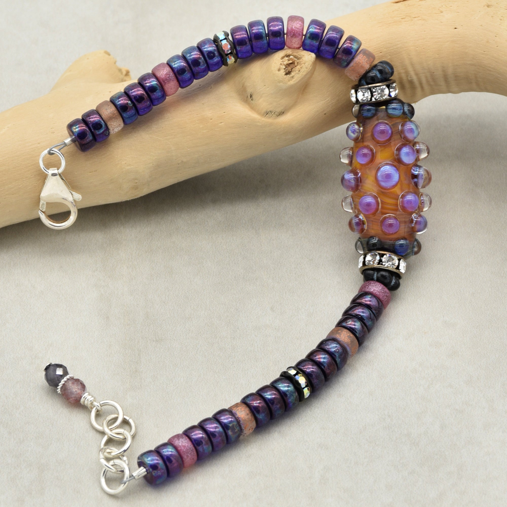 This image shows a bracelet. The length, the clasp style, and the arrangement of beads indicate that it is designed to be worn around the wrist, typical of a bracelet.