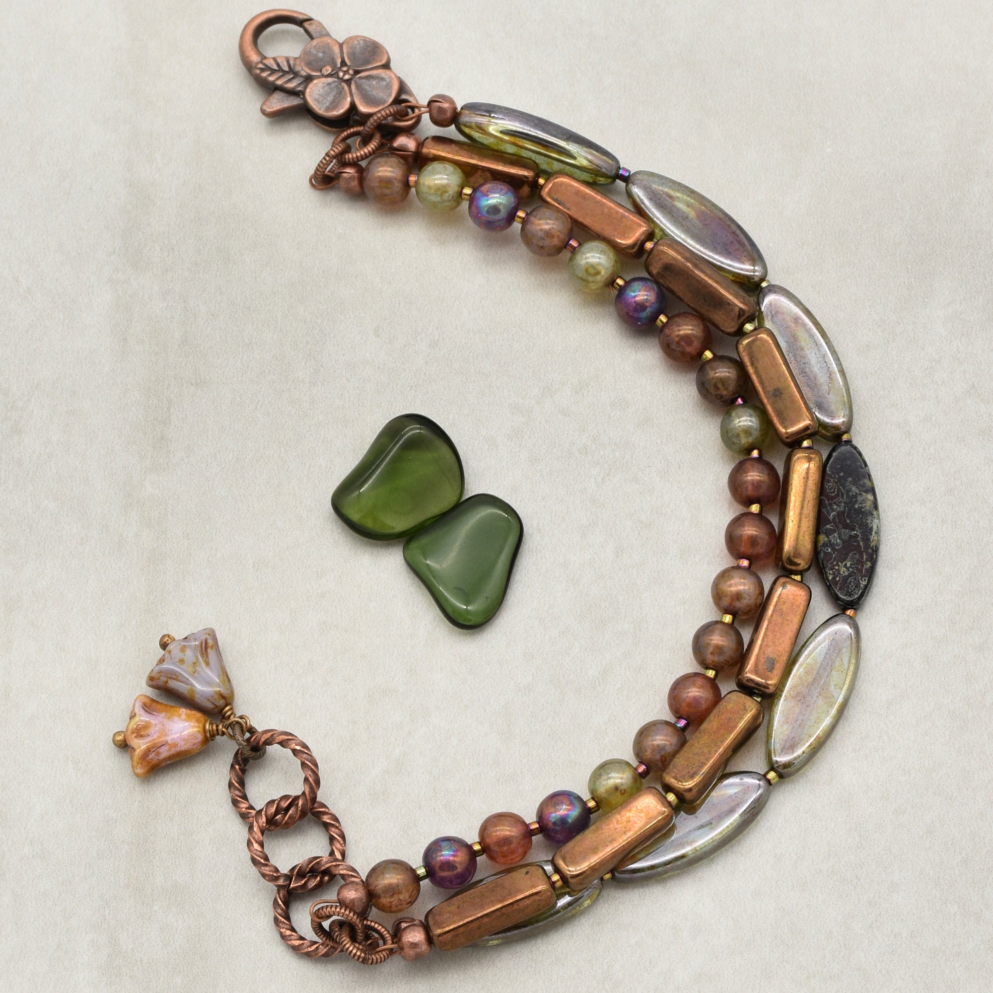 This image shows a bracelet. The overall length and the clasp design, along with the size and arrangement of beads and decorative elements, indicate that it is a bracelet rather than a necklace or earring.