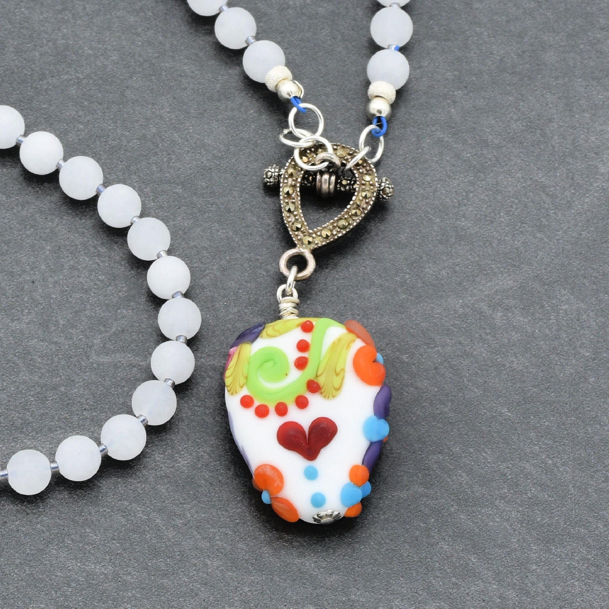 This image shows a necklace. The beaded chain and the decorative pendant hanging from it indicate that it is a necklace.
