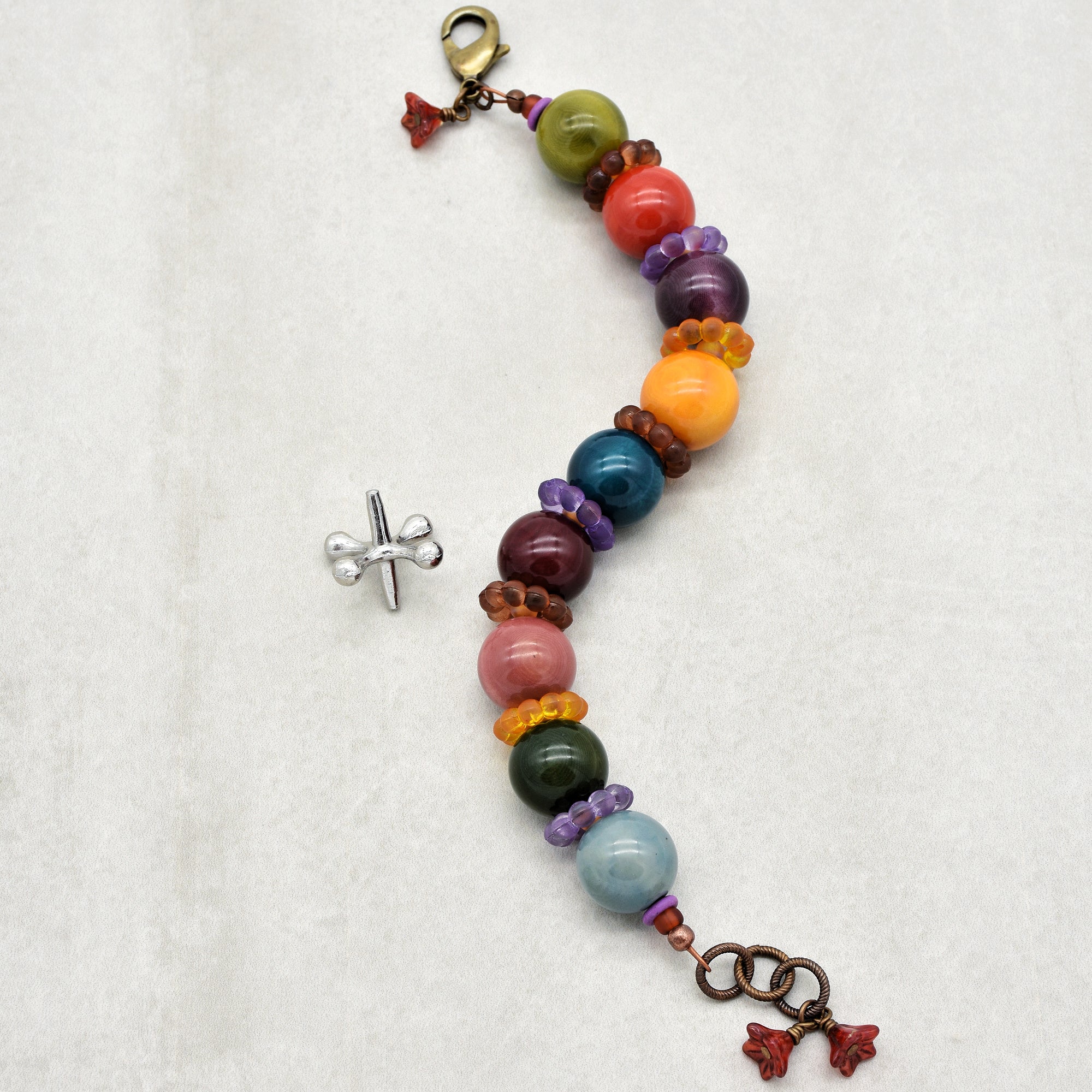 This image shows a bracelet. The size and arrangement of the clasp and beads suggest that it is designed to be worn around the wrist. Earrings are typically smaller and come in pairs, and necklaces usually have a longer length.