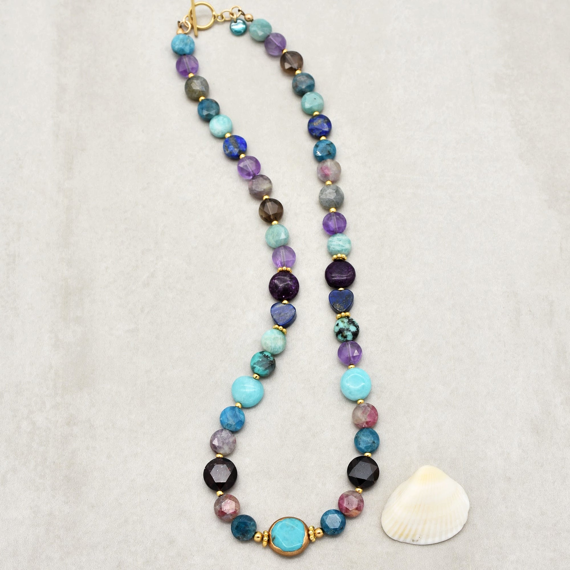 This image shows a necklace. The arrangement and length of the beaded jewelry piece, along with the clasp at the end, indicate that it is designed to be worn around the neck.