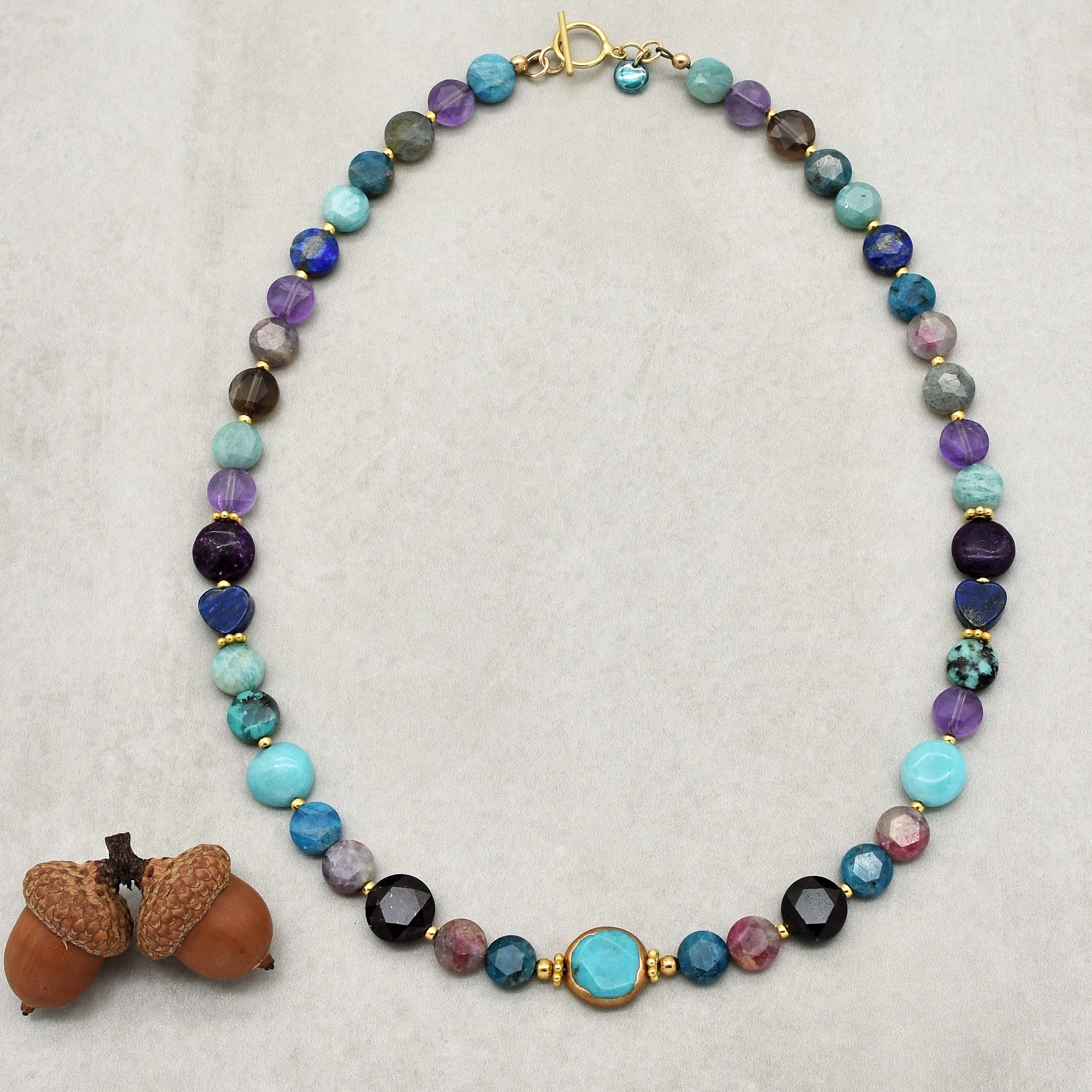 This image shows a necklace. The length and the arrangement of beads around a central clasp suggest it is designed to be worn around the neck. It is not an earring or a bracelet, as those would typically be smaller or have a different structure.