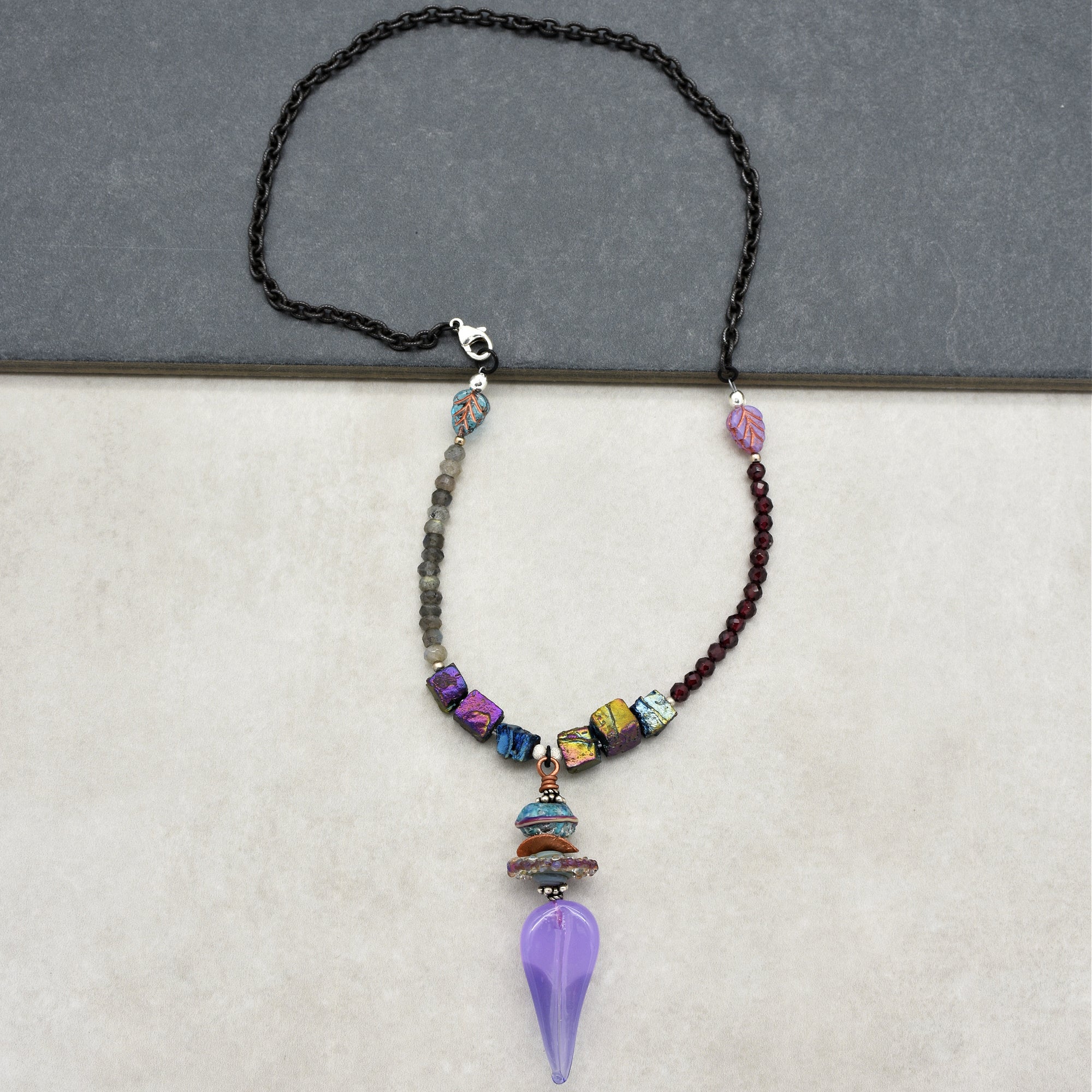 This image shows a necklace. The jewelry has a chain and a pendant-like feature hanging in the center, which is characteristic of a necklace.