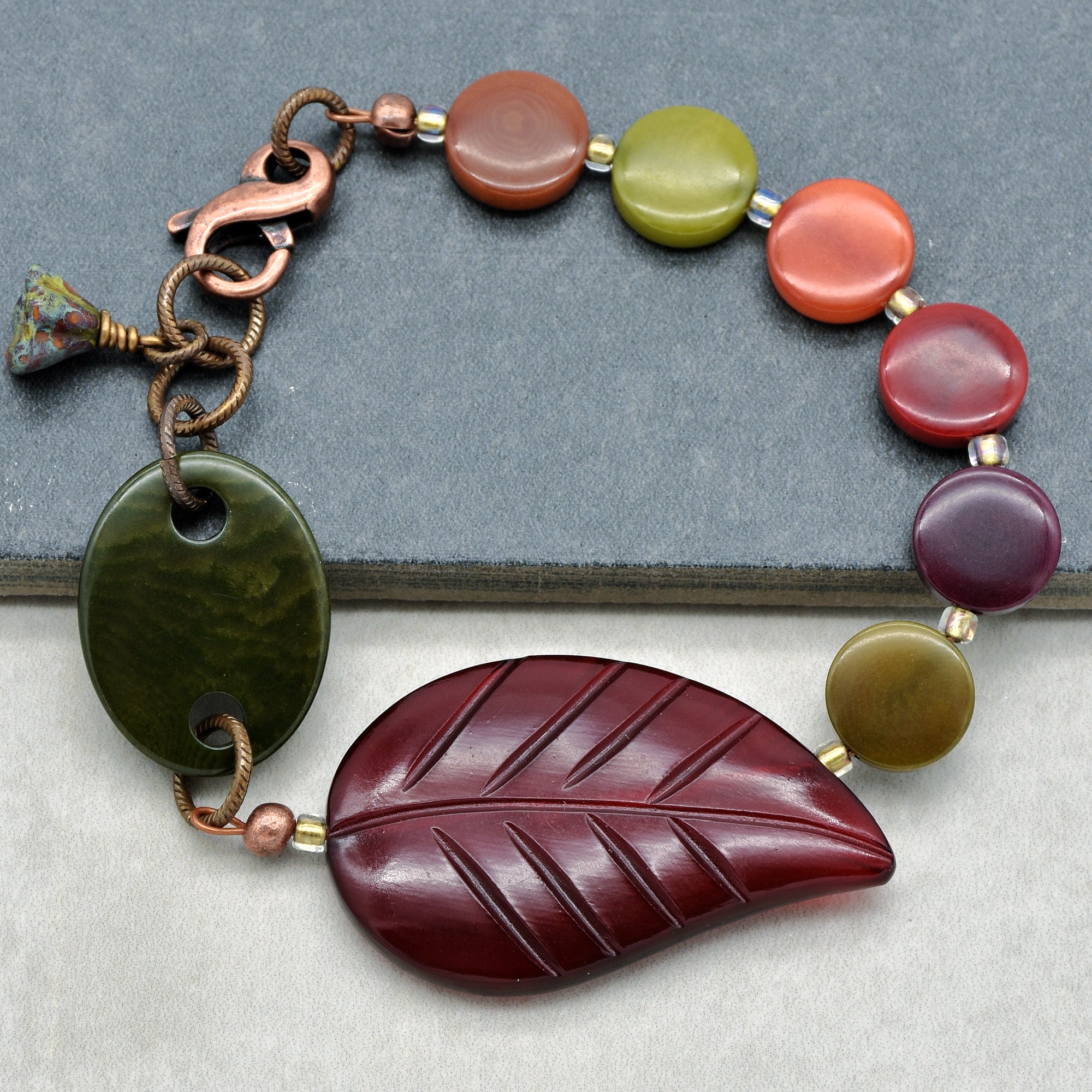 This image shows a bracelet. The size and design, along with the clasp and the way it is laid out, indicate that it is meant to be worn around the wrist.