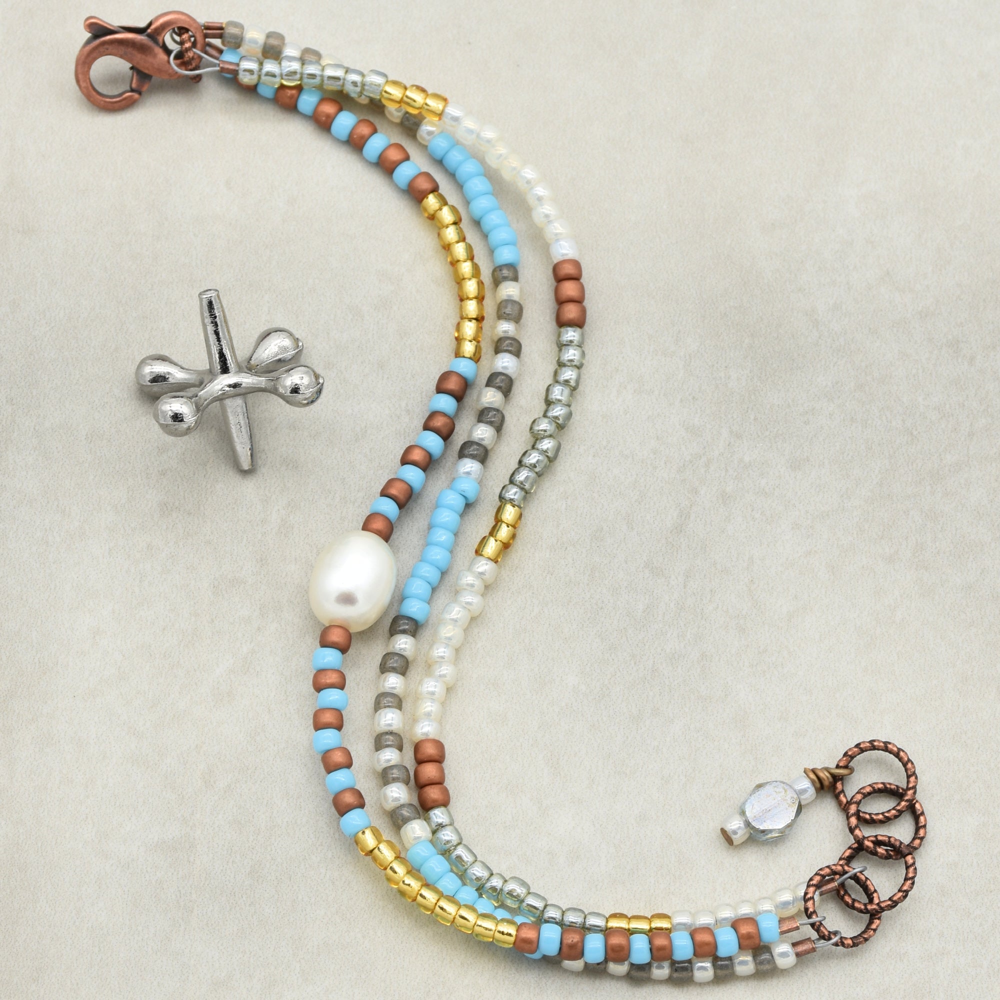 This image shows a piece of jewelry that is most likely a bracelet. The short length, presence of a clasp, and the beaded design strongly suggest it is a bracelet rather than a necklace or earring.