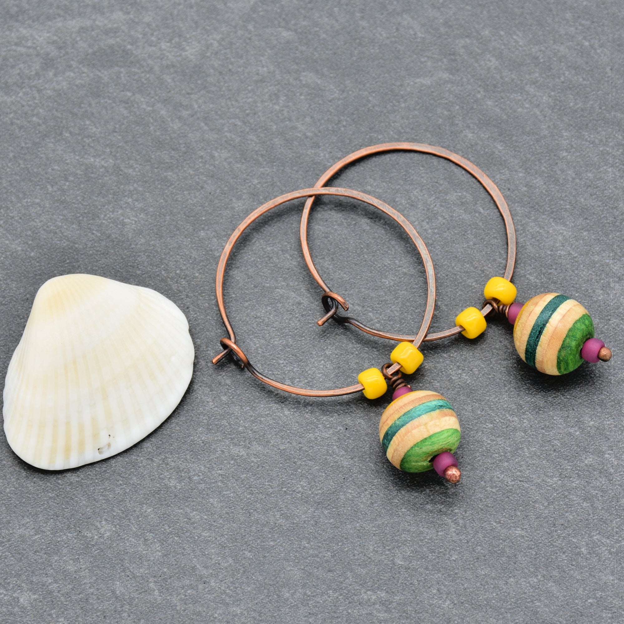 The image shows a pair of earrings. The jewelry consists of hoops with colorful beads attached, which is characteristic of earrings.