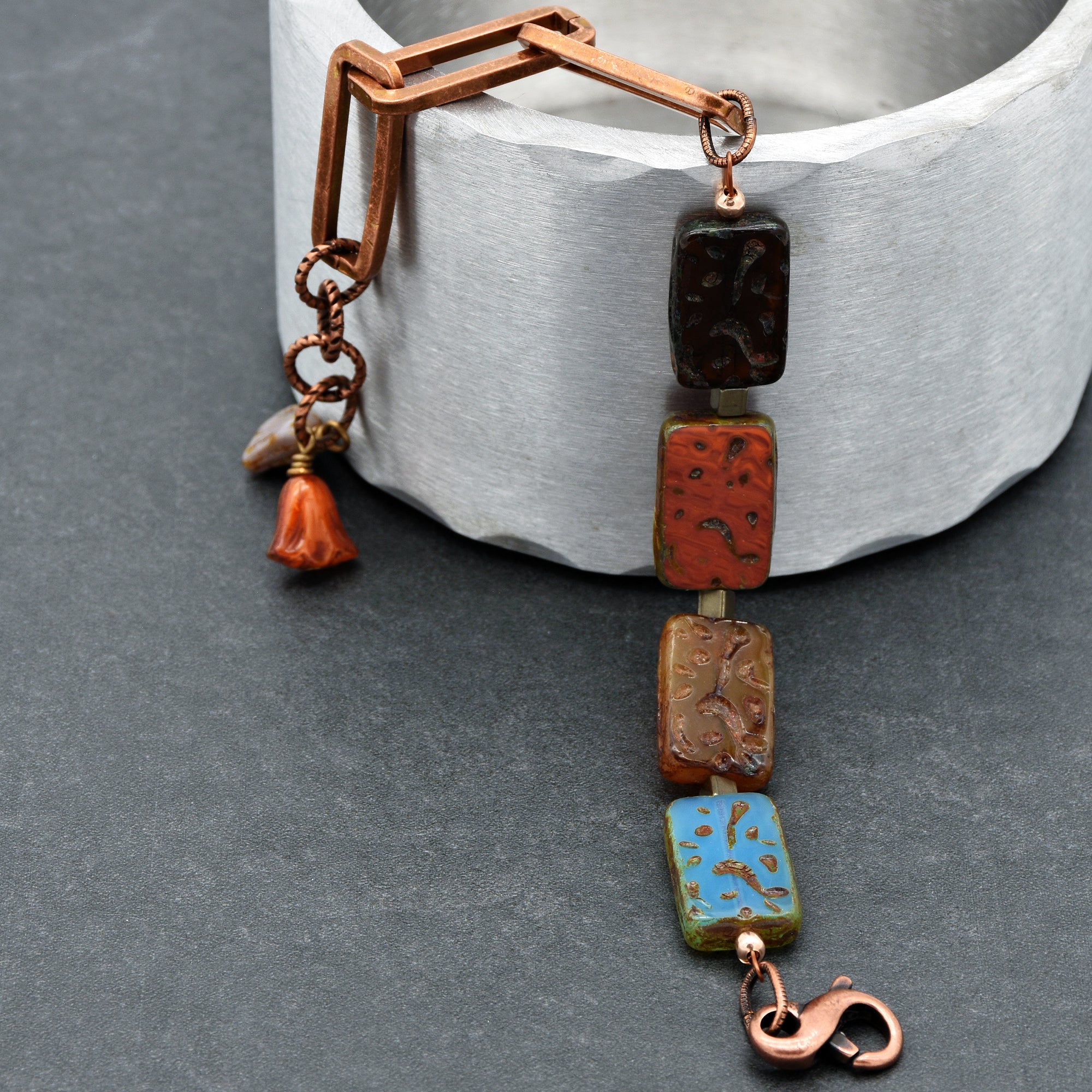 This image shows a bracelet. The presence of a clasp and the length of the jewelry piece, designed to wrap around a wrist, indicate that it is a bracelet.