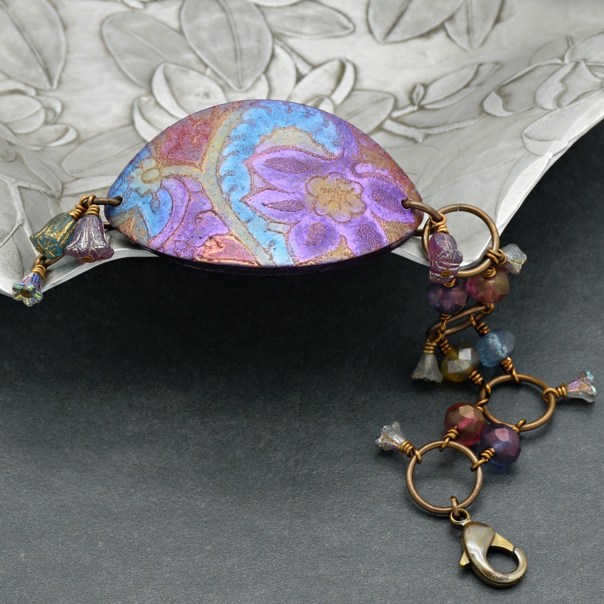 This image shows a bracelet. The clasp and the size/shape of the central decorative piece indicate that it is designed to be worn around the wrist.