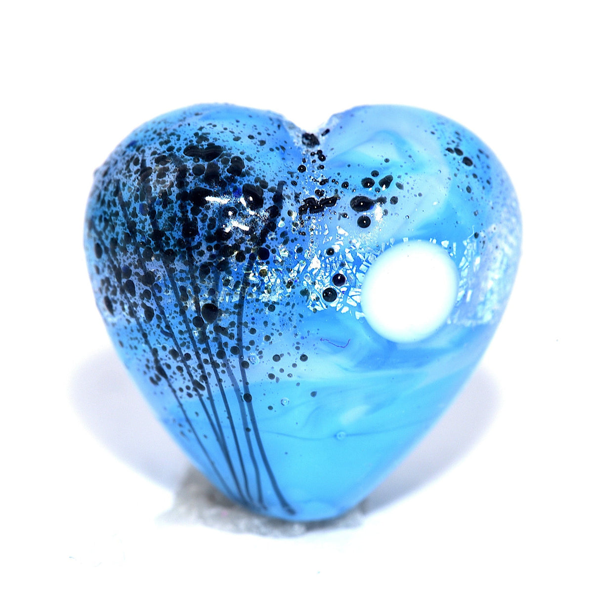 Blue heart-shaped pendant with black specks on a white background