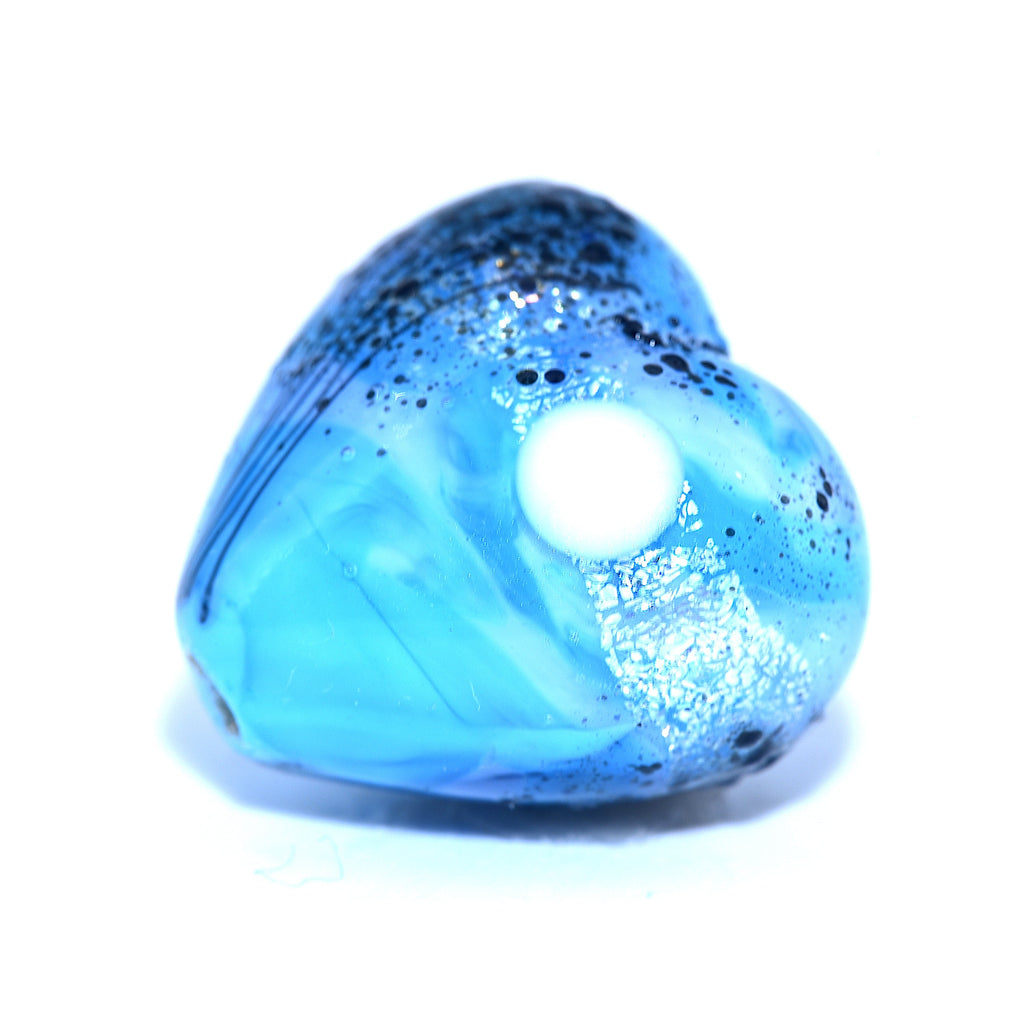 Blue heart-shaped bead with a glowing center on a white background, Grace Ma Lampwork Beads
