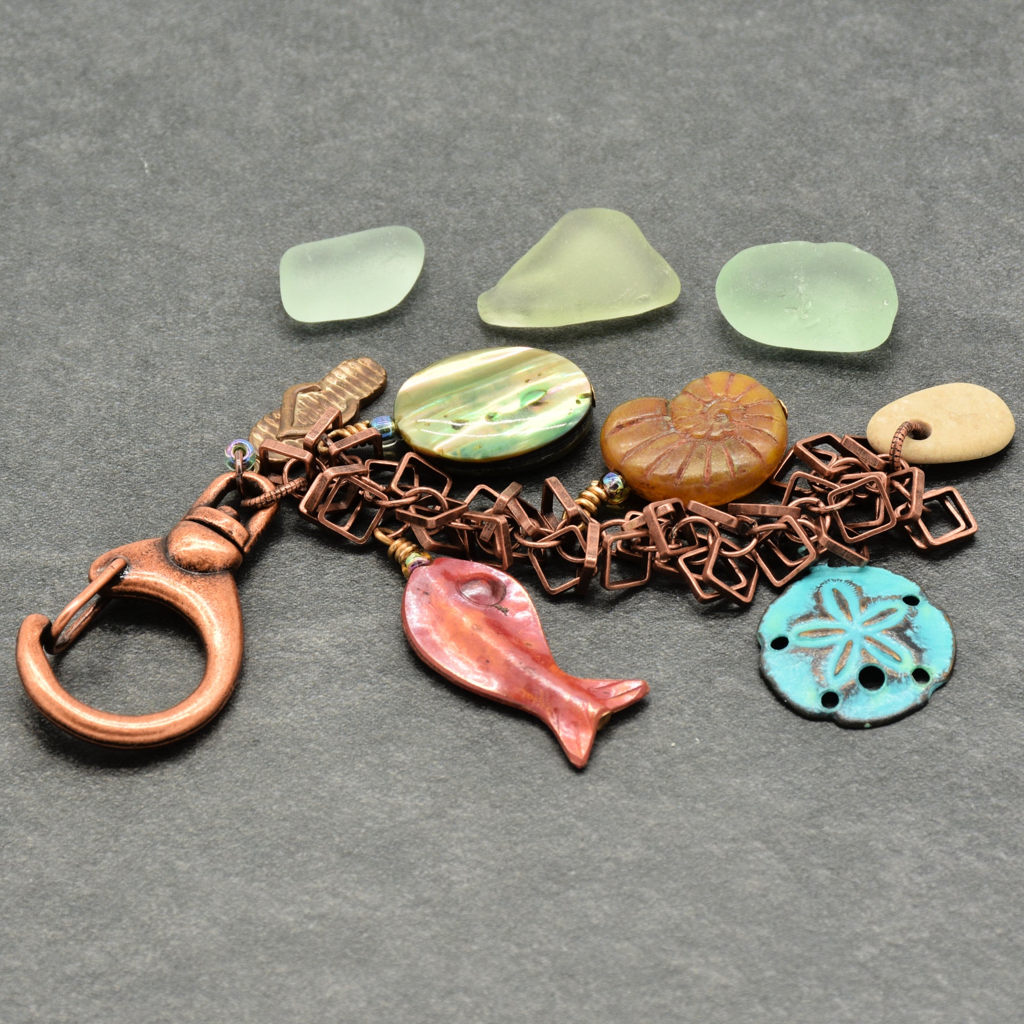 Keychain with beach-themed charms on a gray surface