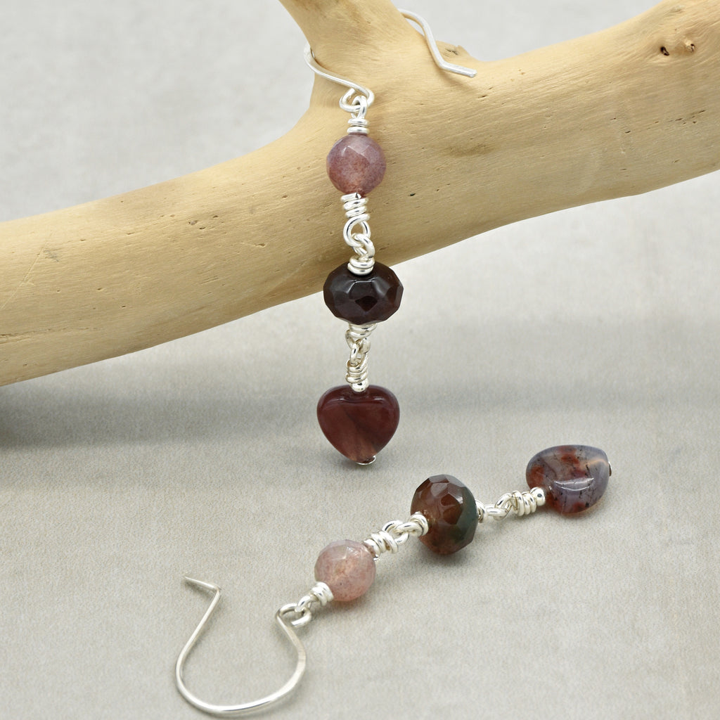 The jewelry in the image is a pair of earrings. The presence of hooks designed for piercing ears indicates that these are earrings.