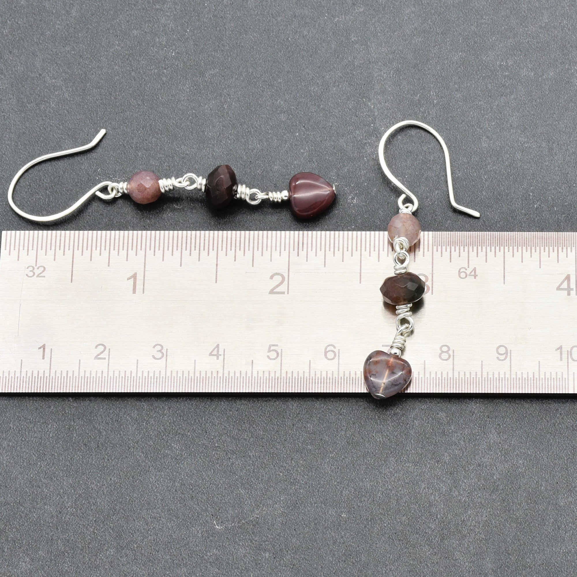 This image shows a pair of earrings. The jewelry pieces are small and have hooks designed for pierced ears, indicating that they are earrings rather than a necklace or bracelet.