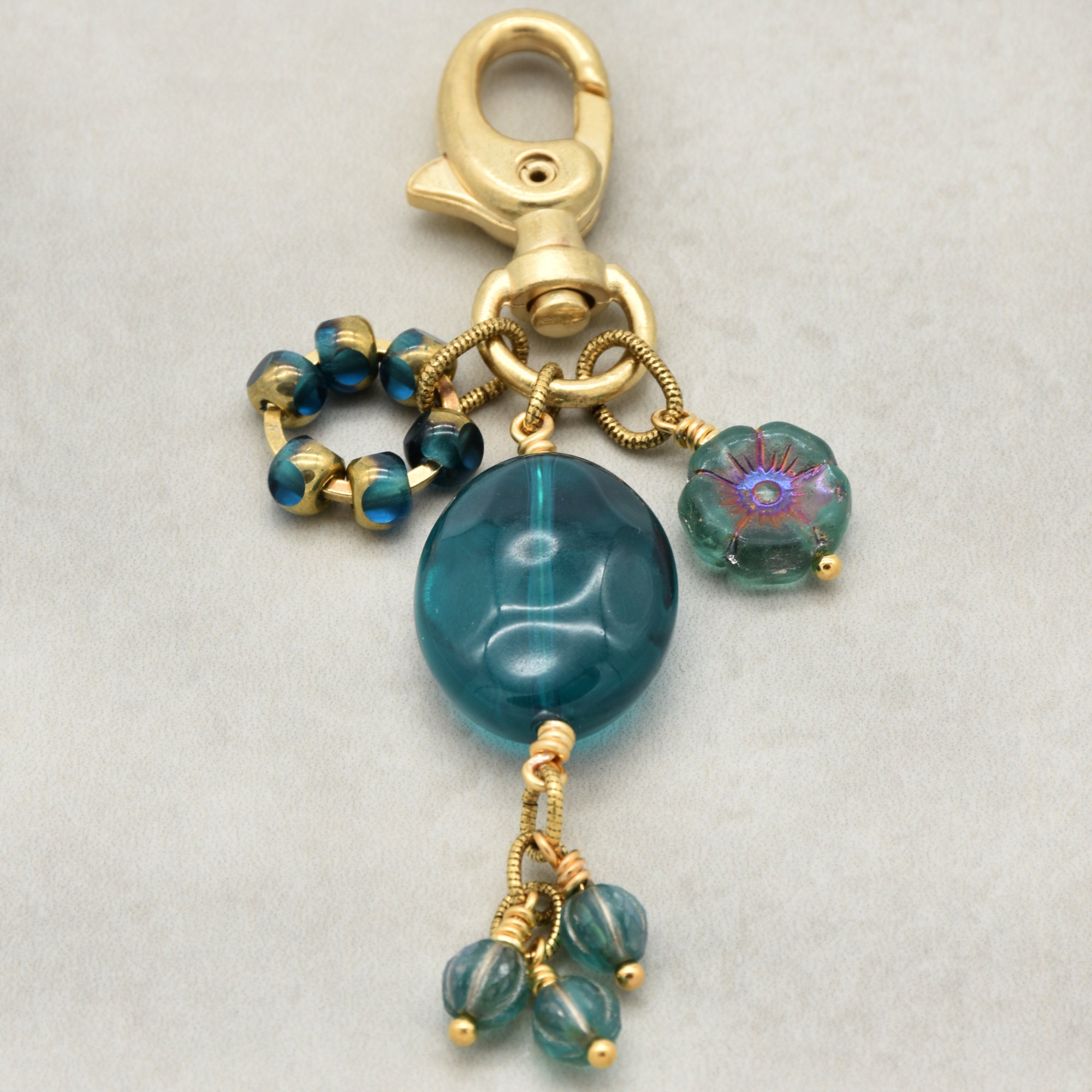 Aqua Blue handbag charm with gold swivel lobster claw on a light background - handmade with love by Ruby Acorn