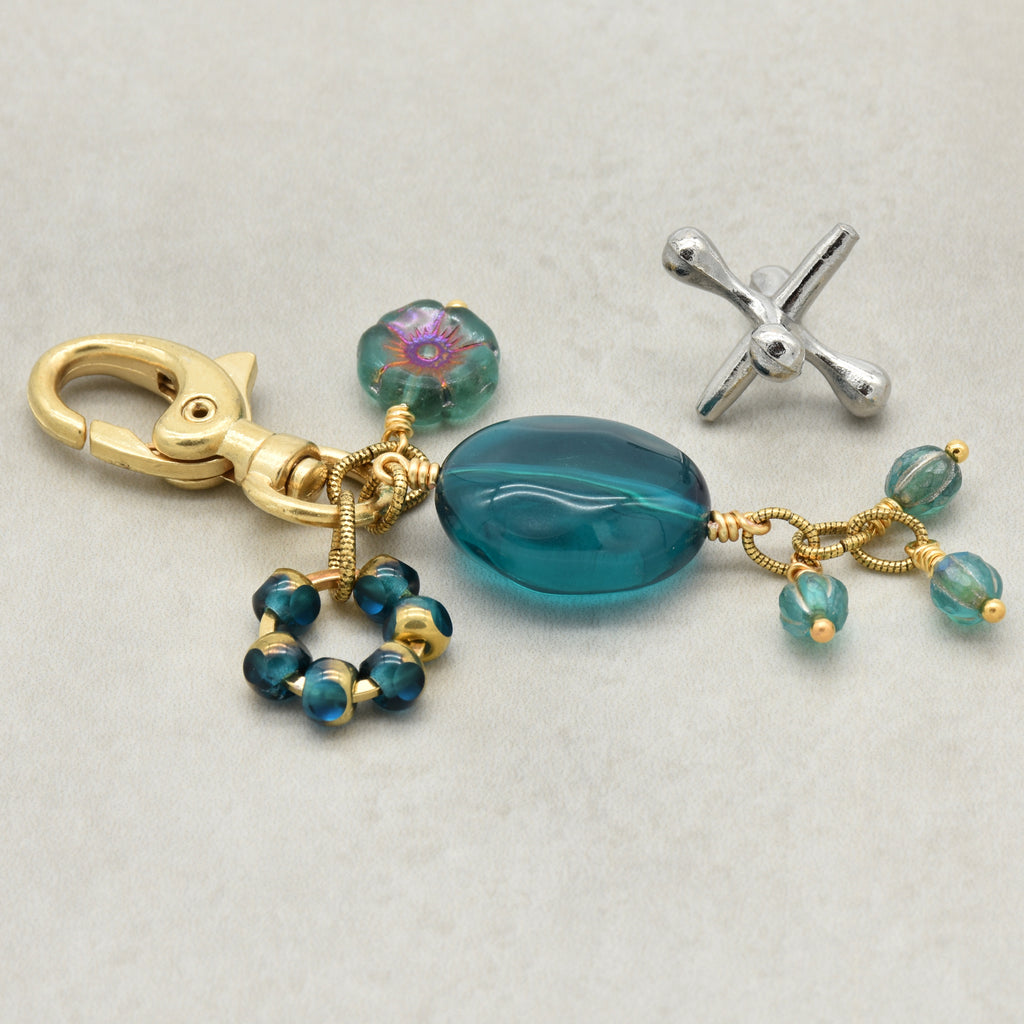 Aqua Blue handbag charm with gold swivel lobster claw on a light background - handmade with love by Ruby Acorn