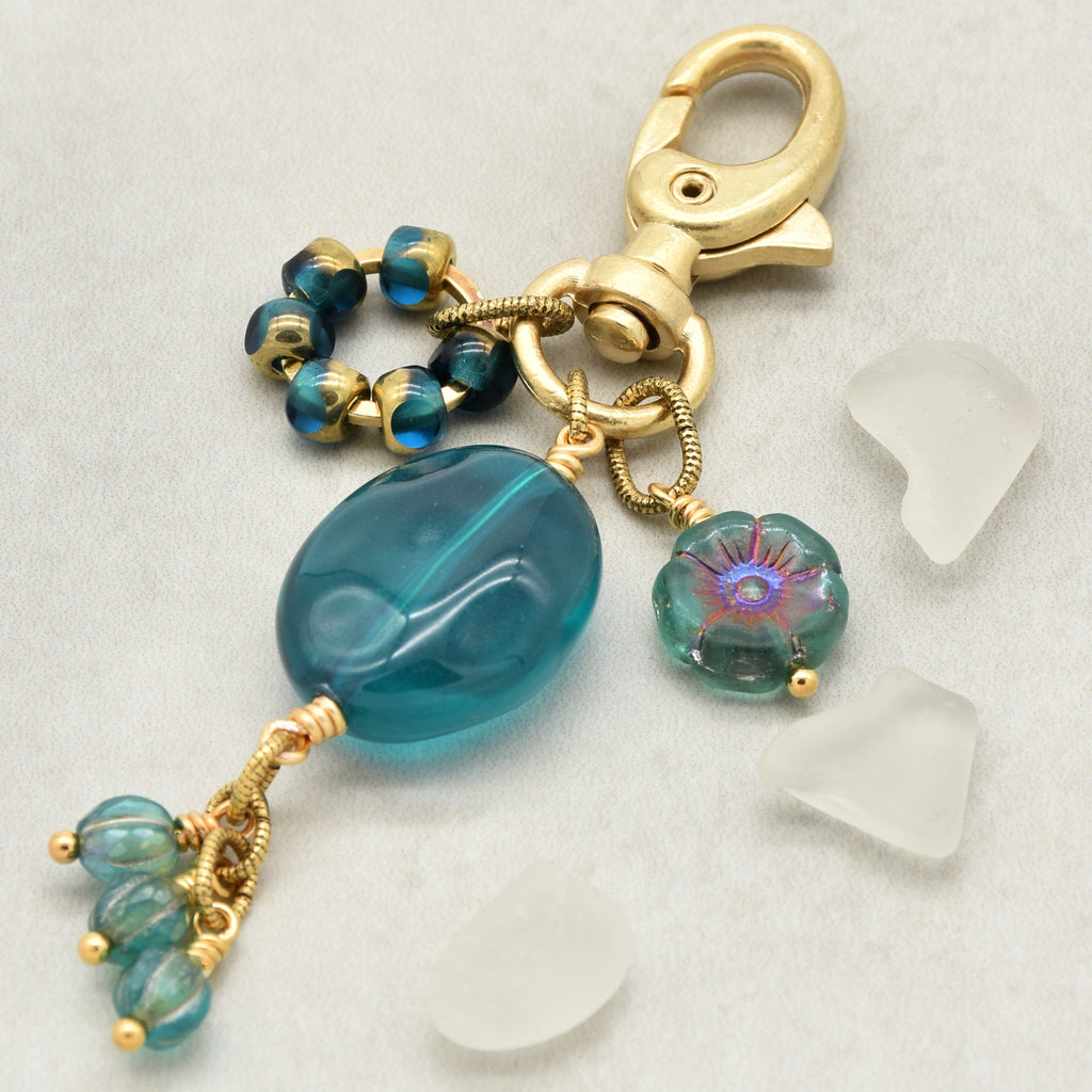 Aqua Blue handbag charm with gold swivel lobster claw on a light background - handmade with love by Ruby Acorn