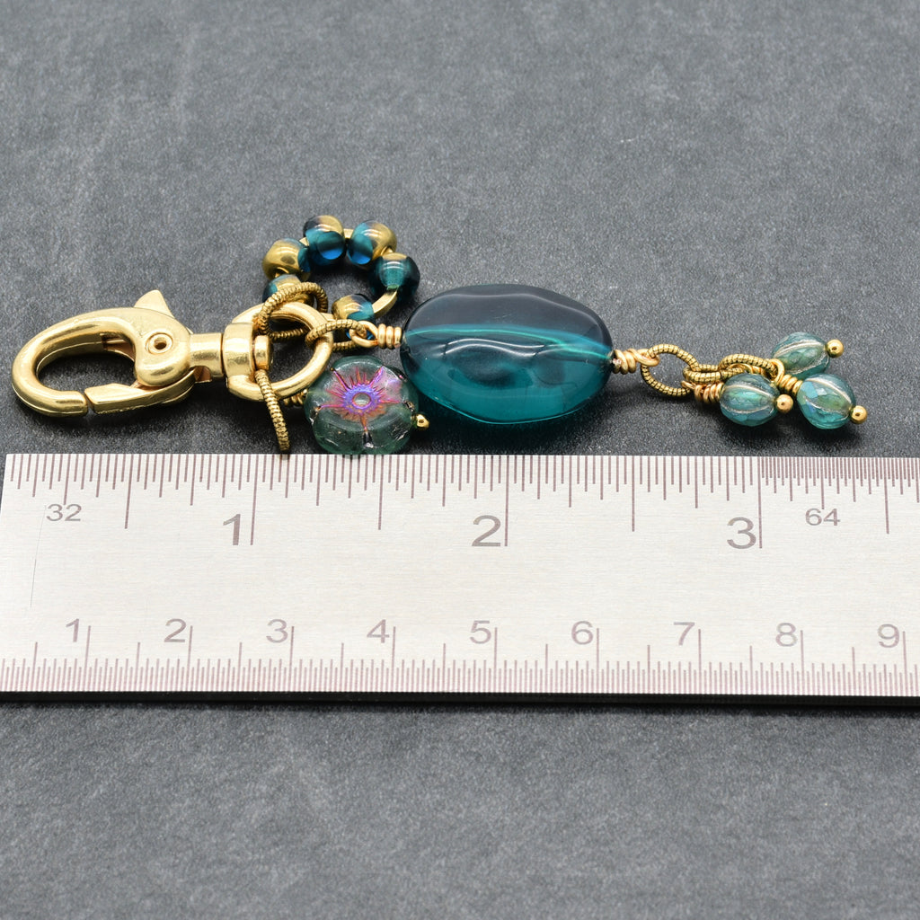 Aqua Blue handbag charm with gold swivel lobster claw next to a ruler for scale - handmade with love by Ruby Acorn