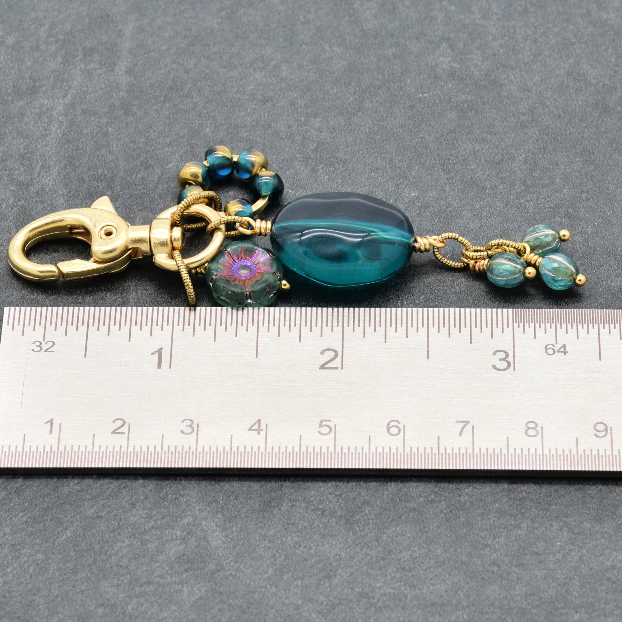 Aqua Blue handbag charm with gold swivel lobster claw next to a ruler for scale - handmade with love by Ruby Acorn