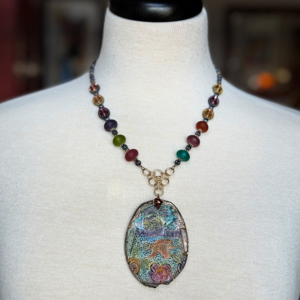 Necklace with a colorful pendant on a mannequin
