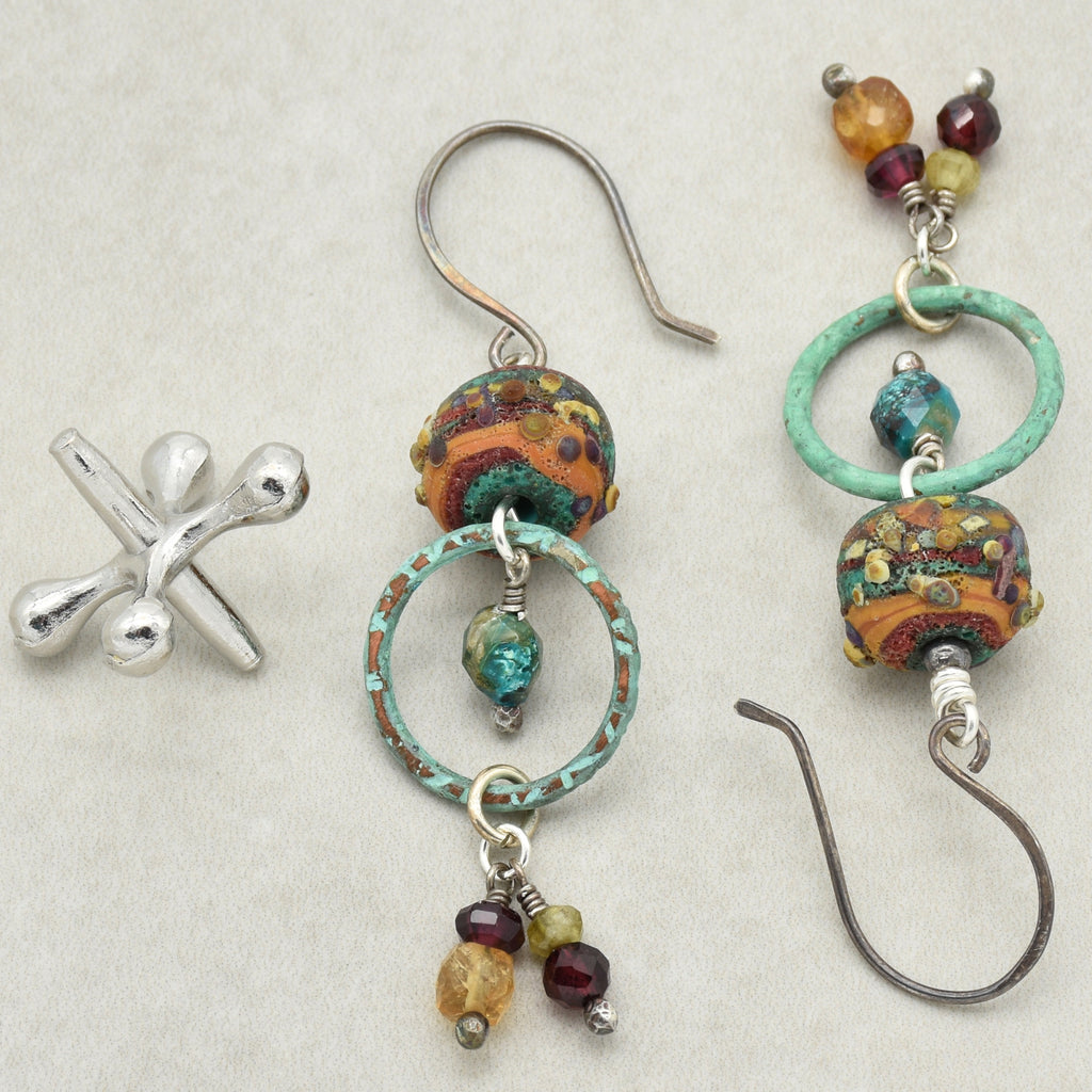 Colorful beaded earrings with oxidized silver hooks on a light background