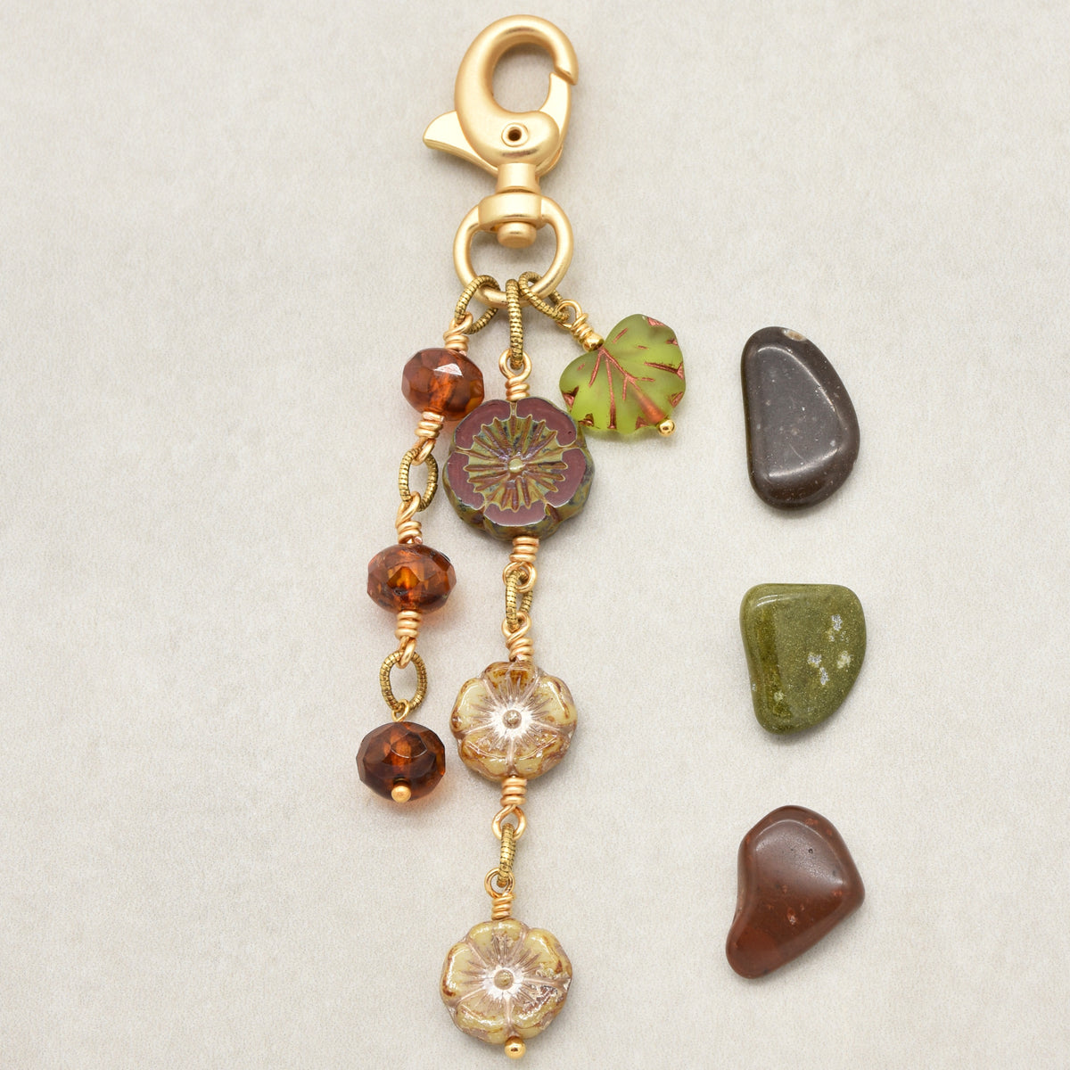 Harvest Bloom Handbag Charm featuring wire-wrapped hibiscus flowers and olive green maple leaf charm, handmade by Ruby Acorn