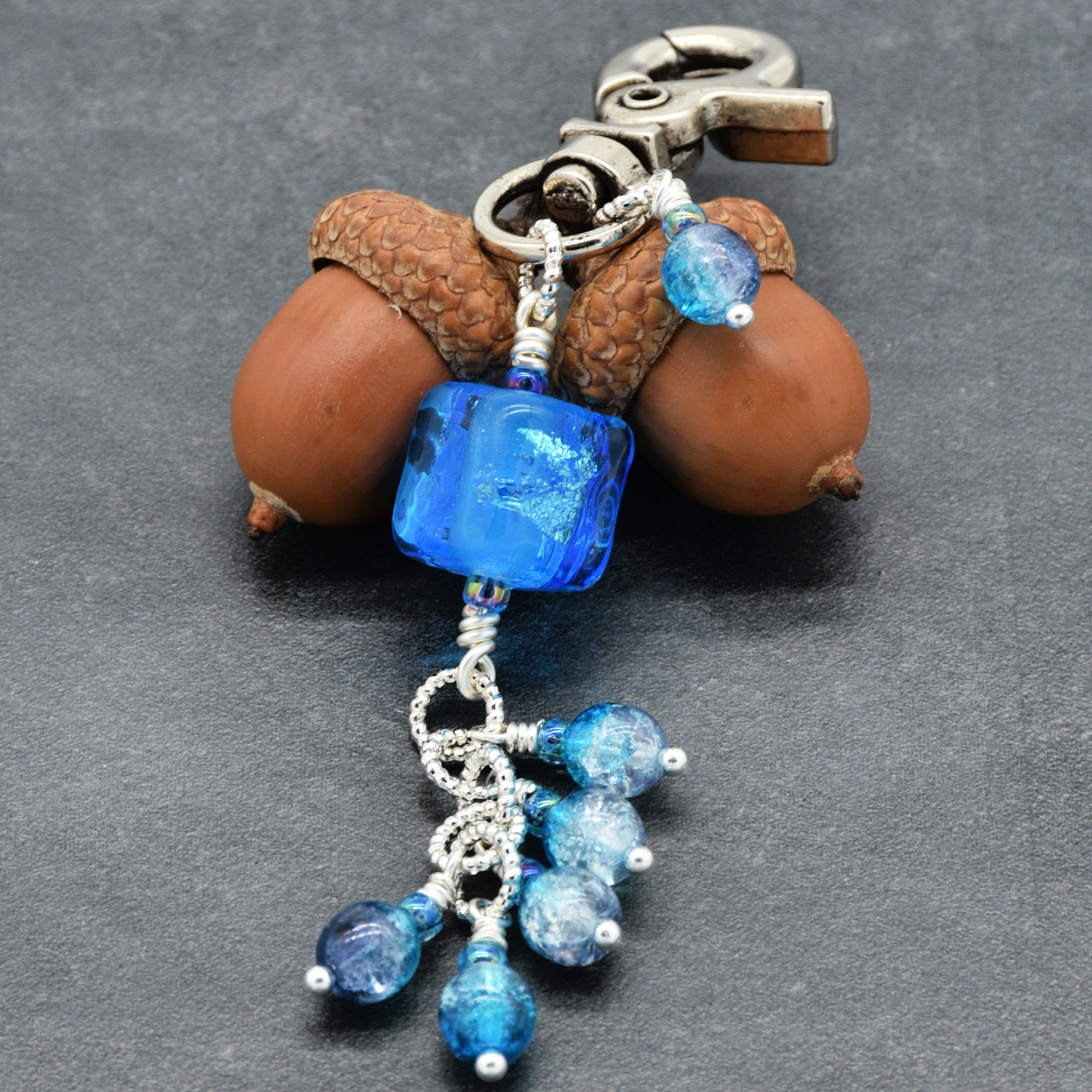 Keychain with blue beads on a gray background