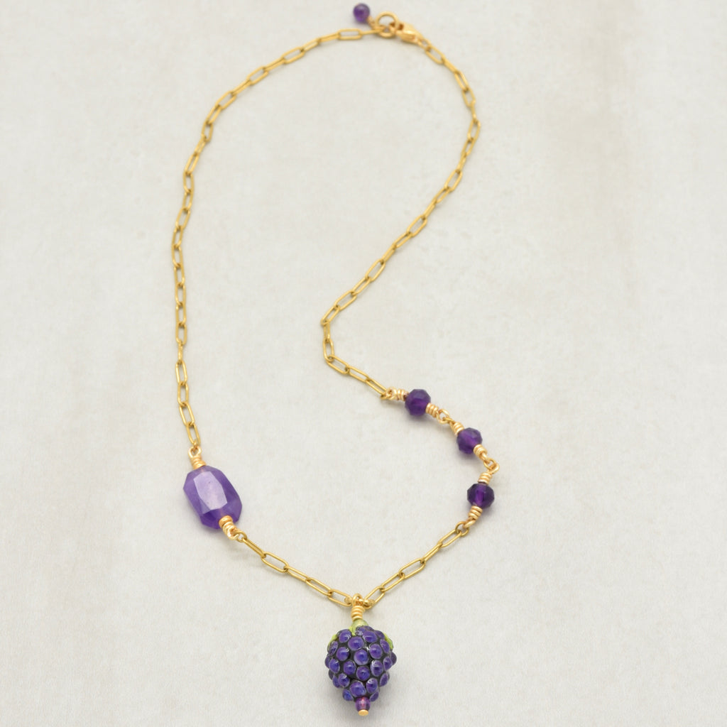 Asymmetrical gold chain necklace with artisan lampwork glass blackberry focal and amethyst on a light background - handmade with love by Ruby Acorn