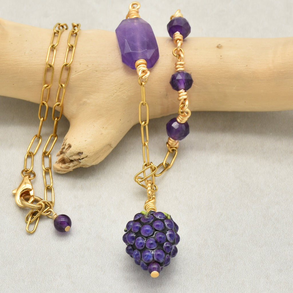 Closeup of asymmetrical gold chain necklace with artisan lampwork glass blackberry focal and amethyst on a branch - handmade with love by Ruby Acorn