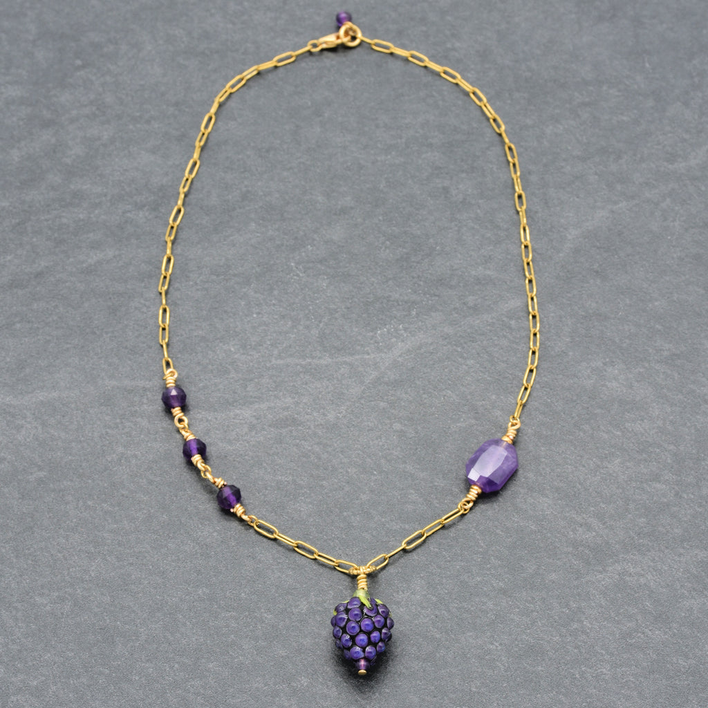 Asymmetrical gold chain necklace with artisan lampwork glass blackberry focal and amethyst on a gray background - handmade with love by Ruby Acorn