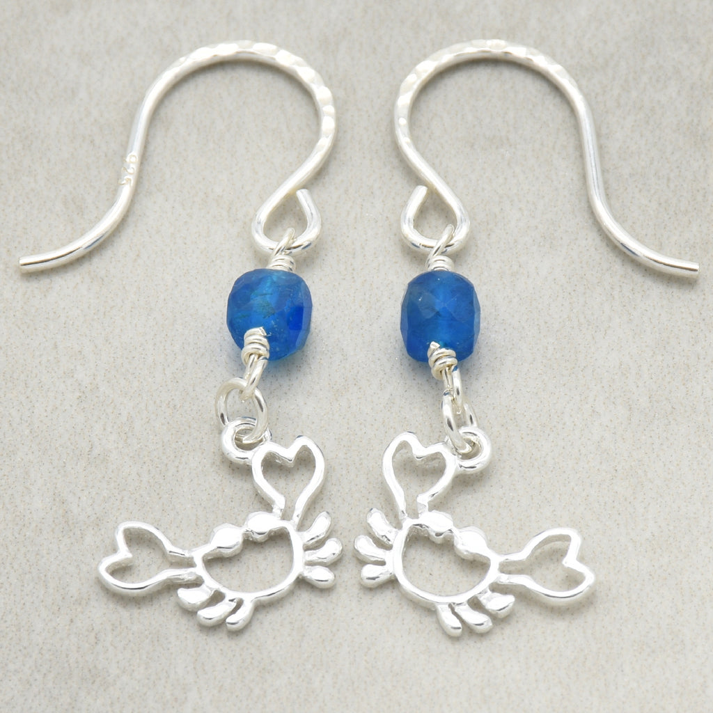 Sterling silver dangle earrings with crab charms, apatite, and silver ear wires on a light surface - handmade with love by Ruby Acorn
