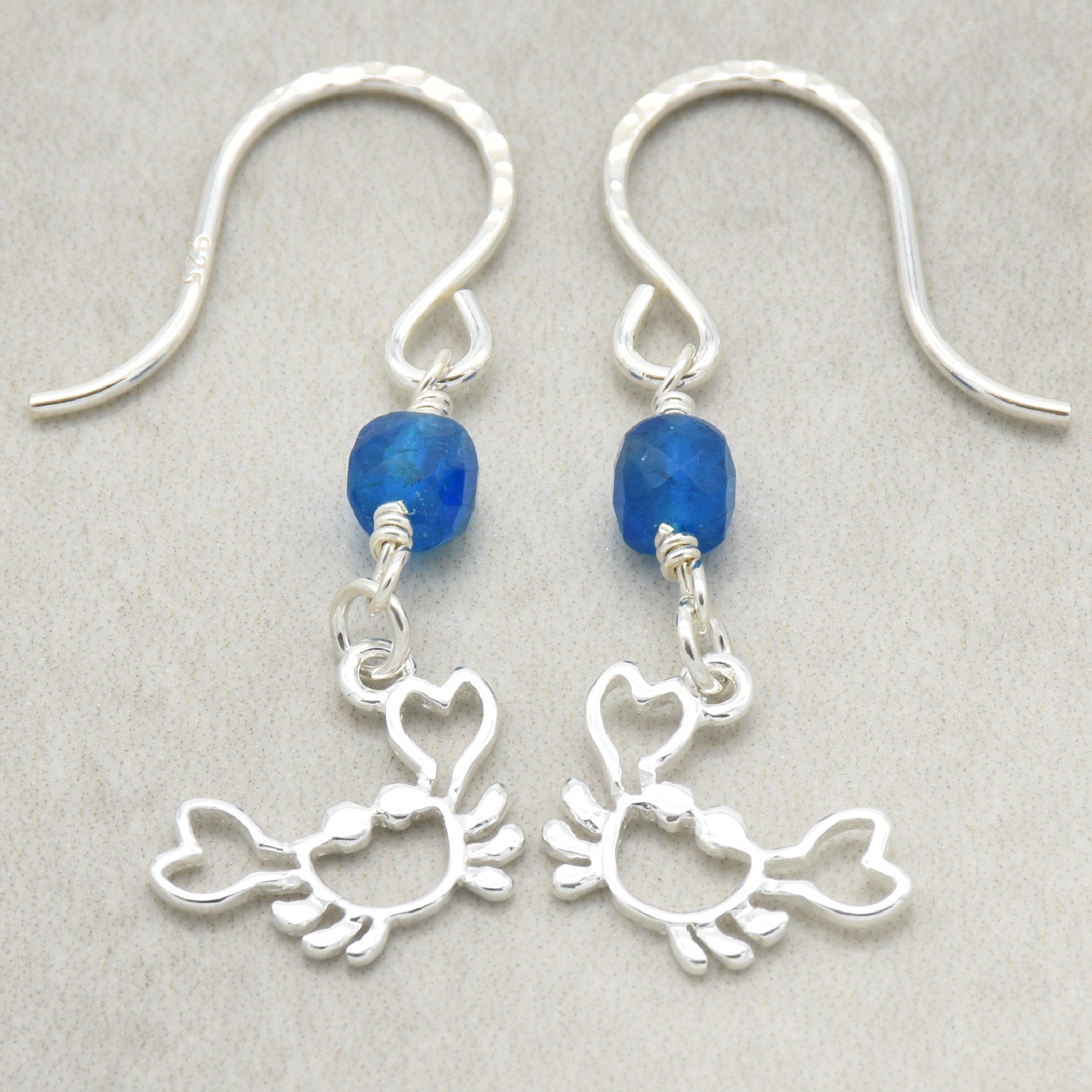 Sterling silver dangle earrings with crab charms, apatite, and silver ear wires on a light surface - handmade with love by Ruby Acorn
