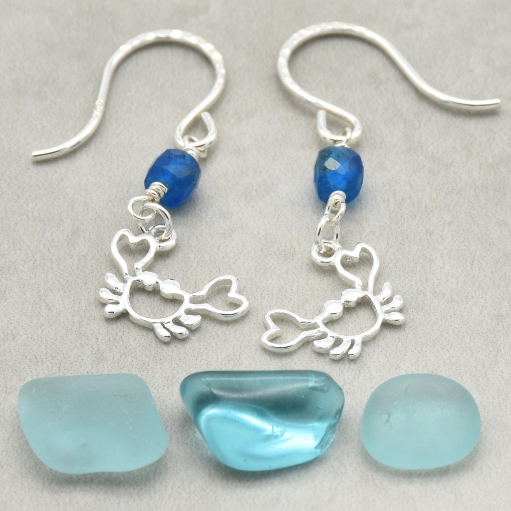 Sterling silver dangle earrings with crab charms, apatite, and silver ear wires on a light surface - handmade with love by Ruby Acorn