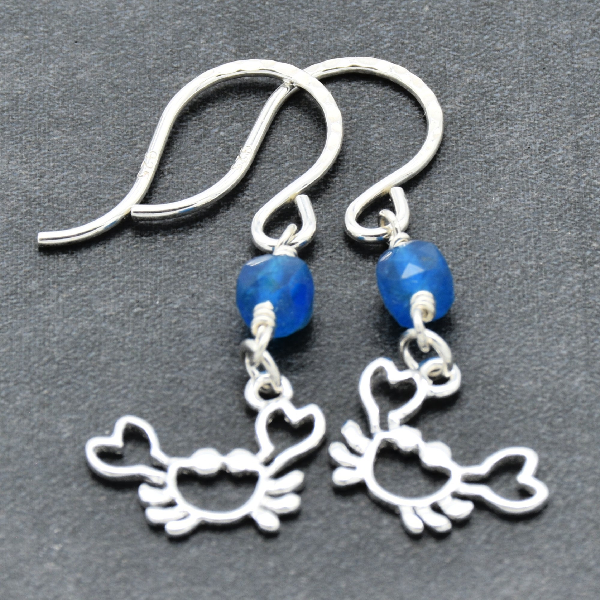 Sterling silver dangle earrings with crab charms, apatite, and silver ear wires on a gray surface - handmade with love by Ruby Acorn