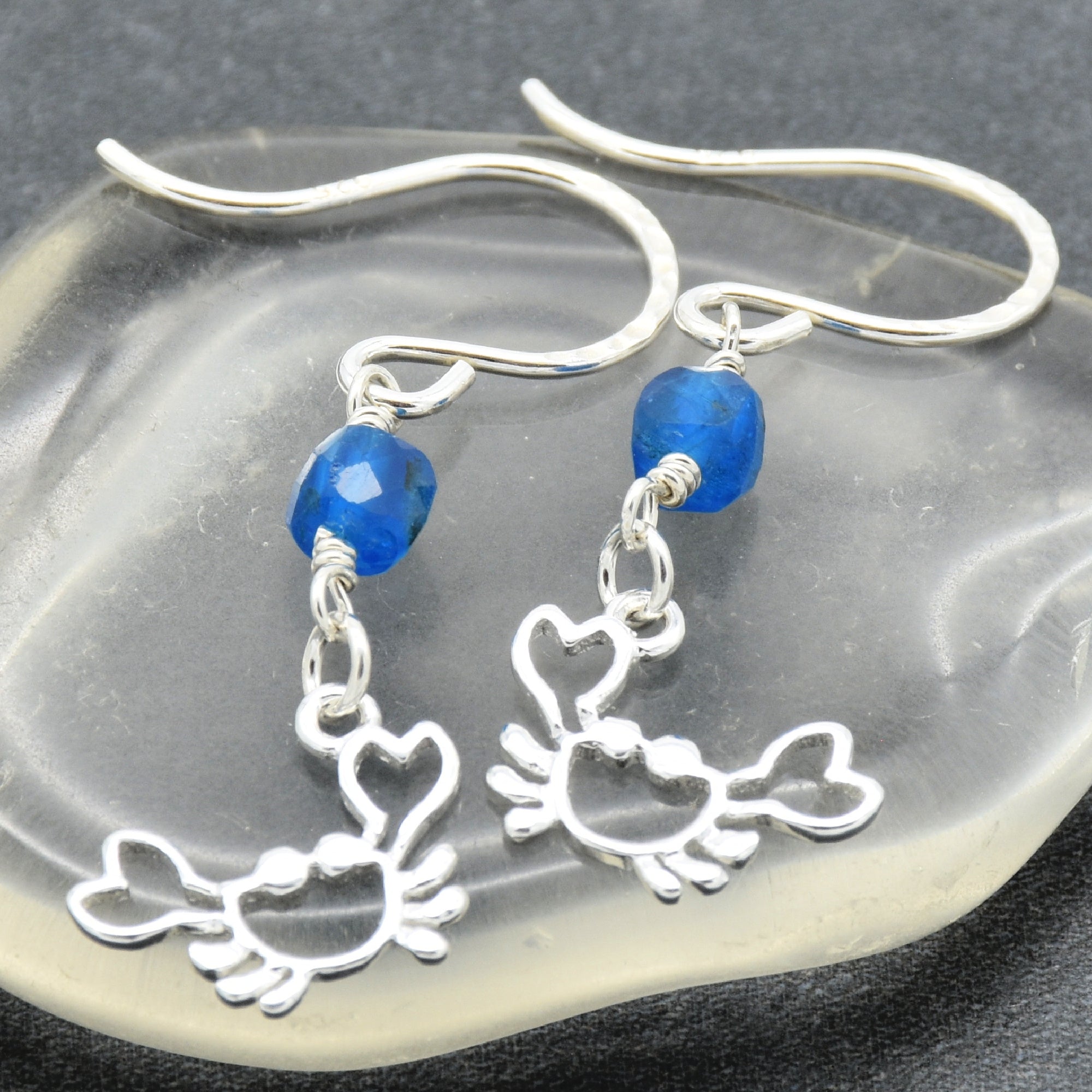 Sterling silver dangle earrings with crab charms, apatite, and silver ear wires on a glass surface - handmade with love by Ruby Acorn