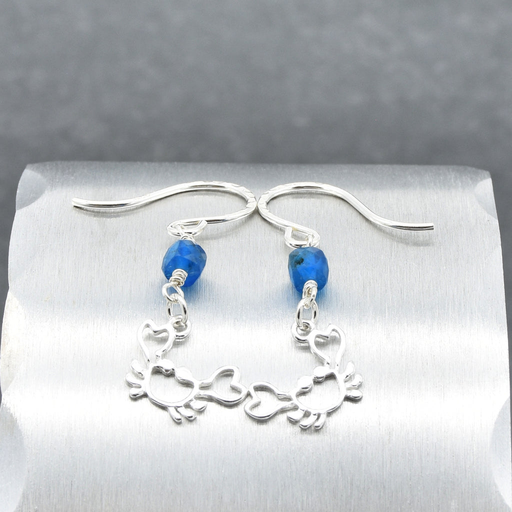 Sterling silver dangle earrings with crab charms, apatite, and silver ear wires on a silver surface - handmade with love by Ruby Acorn