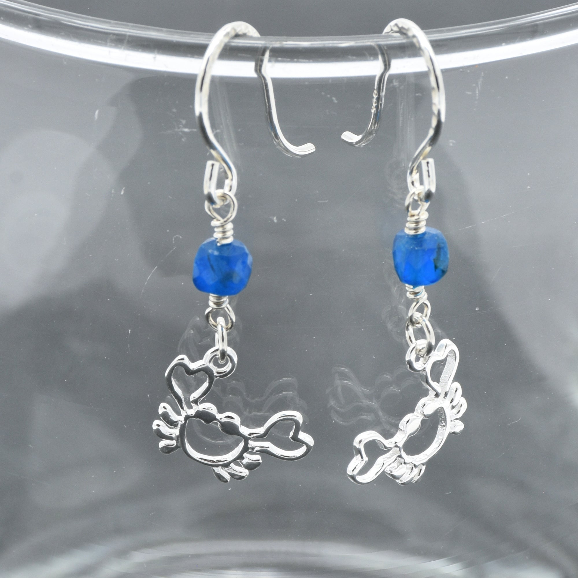 Sterling silver dangle earrings with crab charms, apatite, and silver ear wires on a glass surface - handmade with love by Ruby Acorn