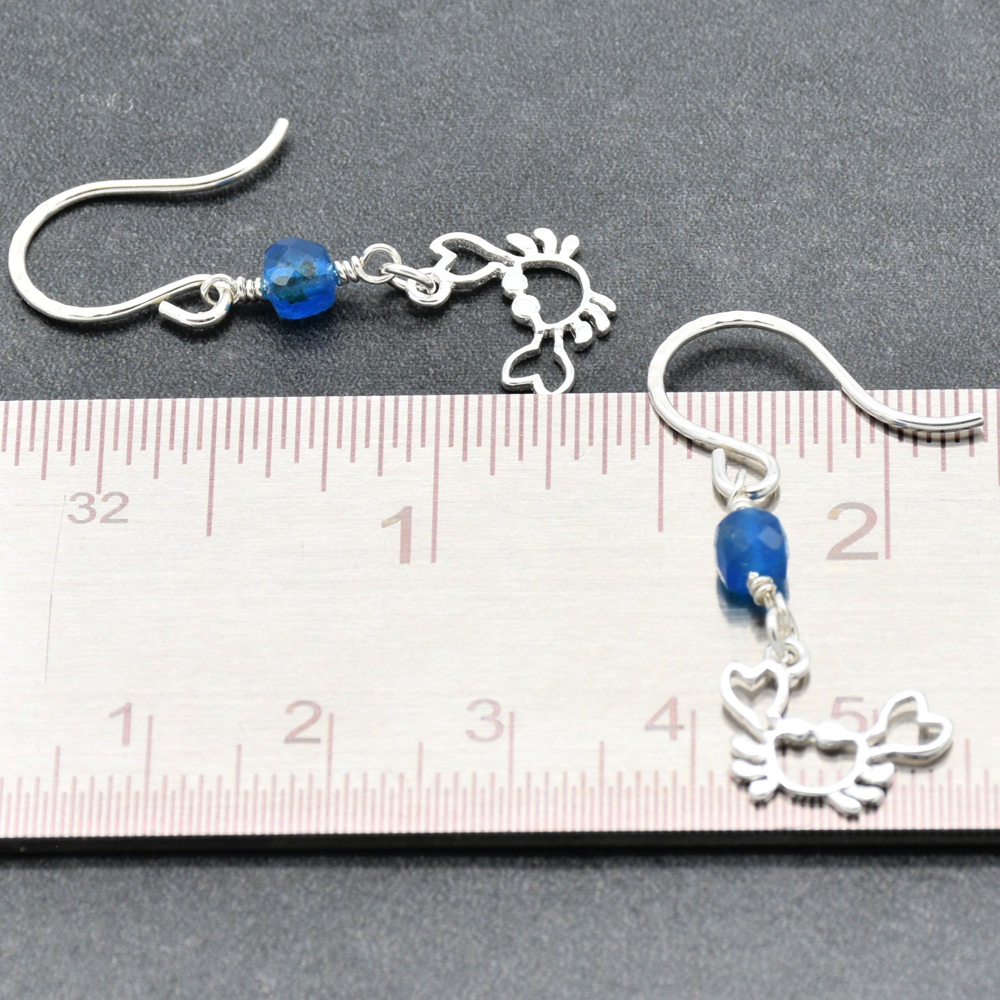 Sterling silver dangle earrings with crab charms, apatite, and silver ear wires beside a ruler for scale - handmade with love by Ruby Acorn