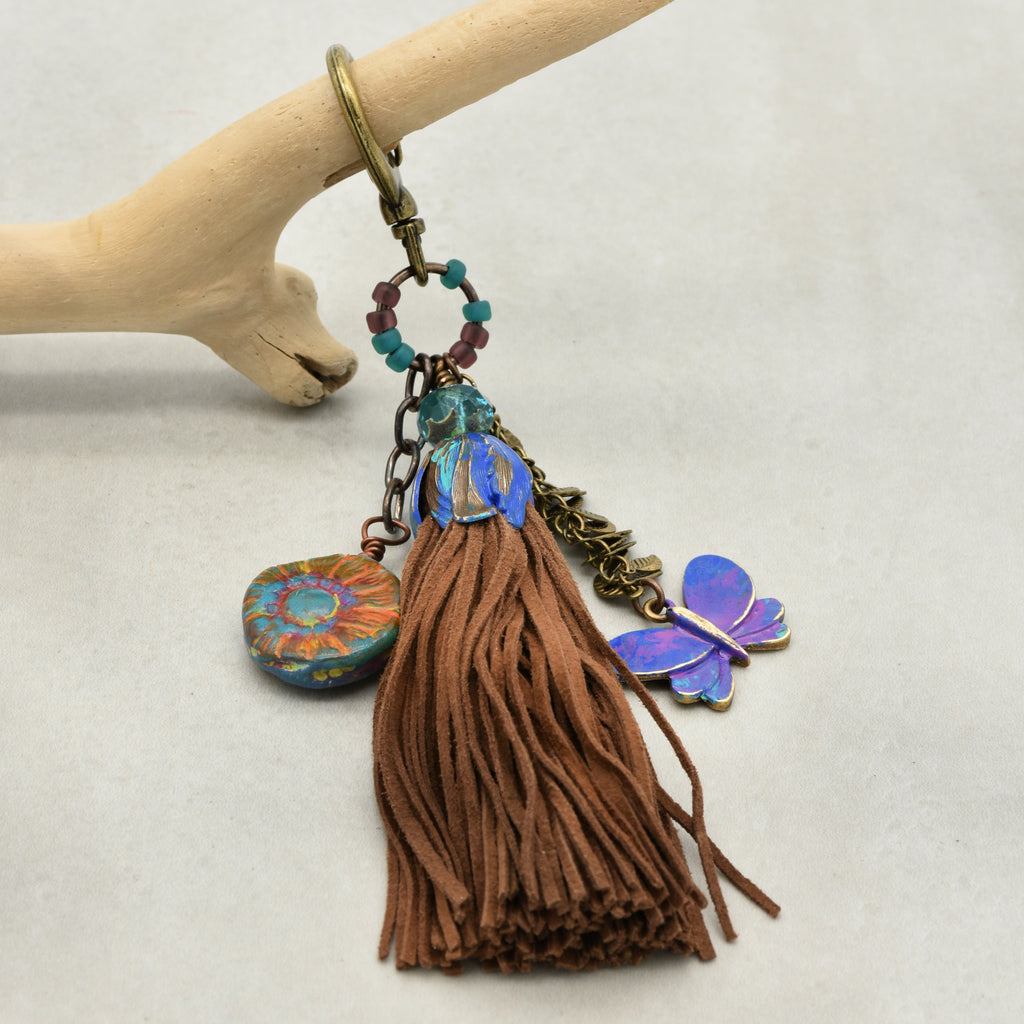 Keychain with tassel and colorful charms on a white background