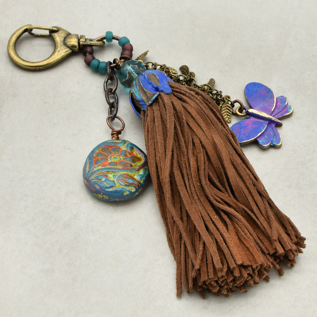 Keychain with tassel and colorful charms on a beige background
