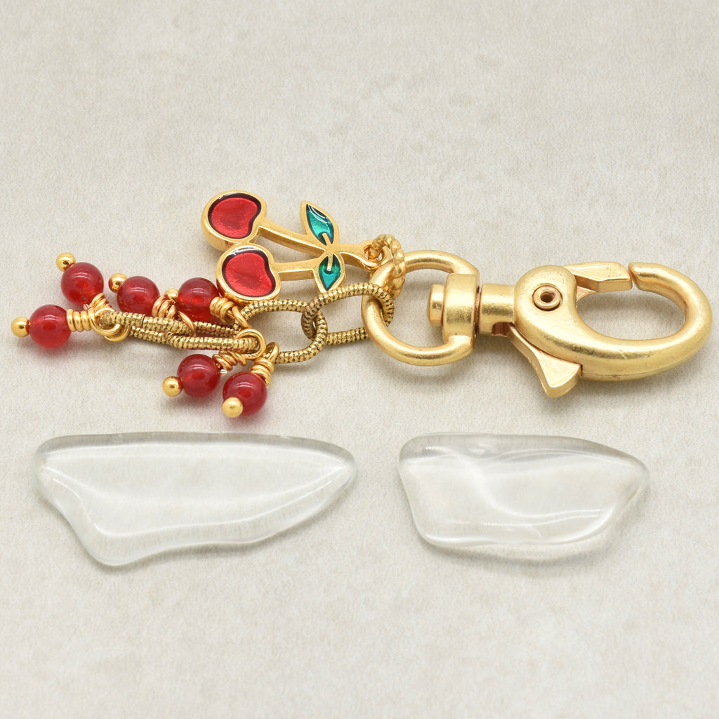 Gold-plated keychain accessory with red cherry charm, red jade beads on a light gray background - made with love in Colorado by Ruby Acorn.