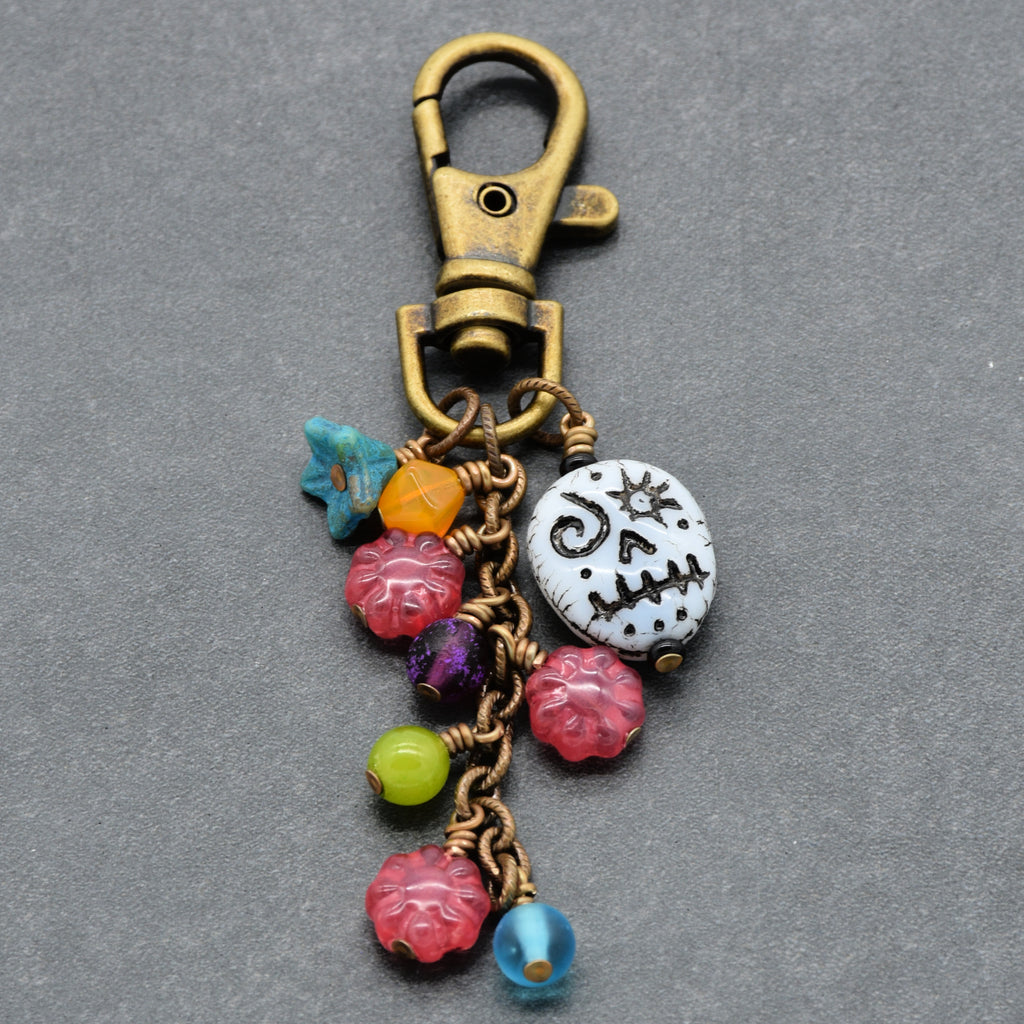 Colorful keychain with beads and a lobster claw clasp on a gray background