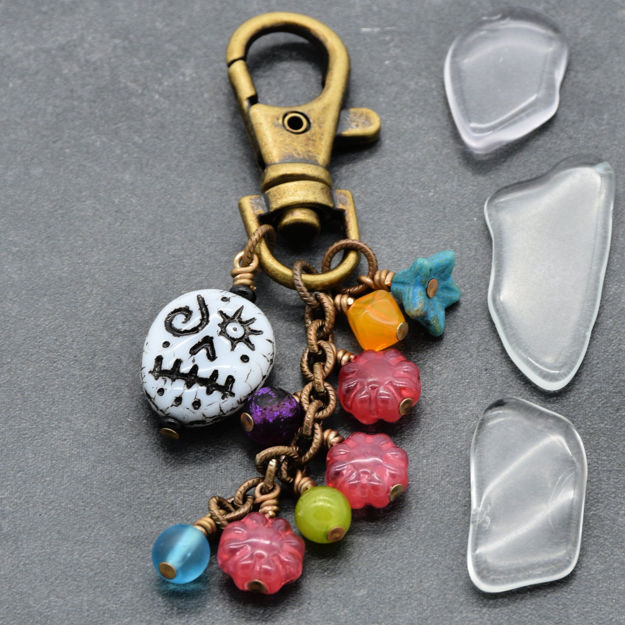 Keychain with colorful charms on a gray background