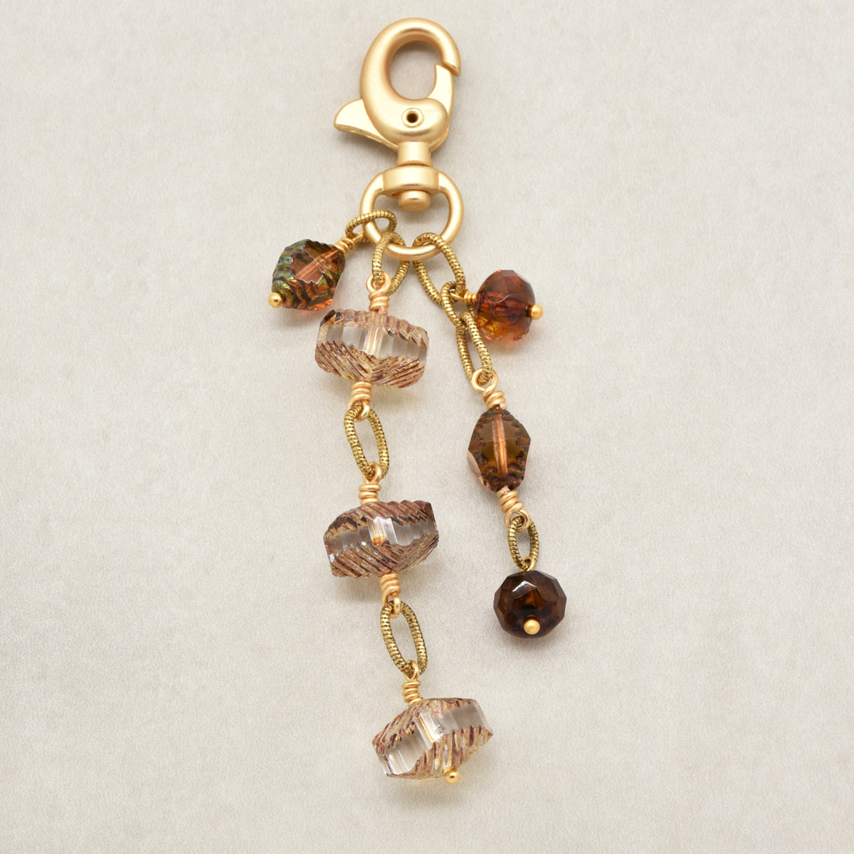 Smoky Reverie Handbag Charm featuring wire-wrapped etched Czech glass rondelles in smoky topaz with gold lobster claw, handmade by Ruby Acorn