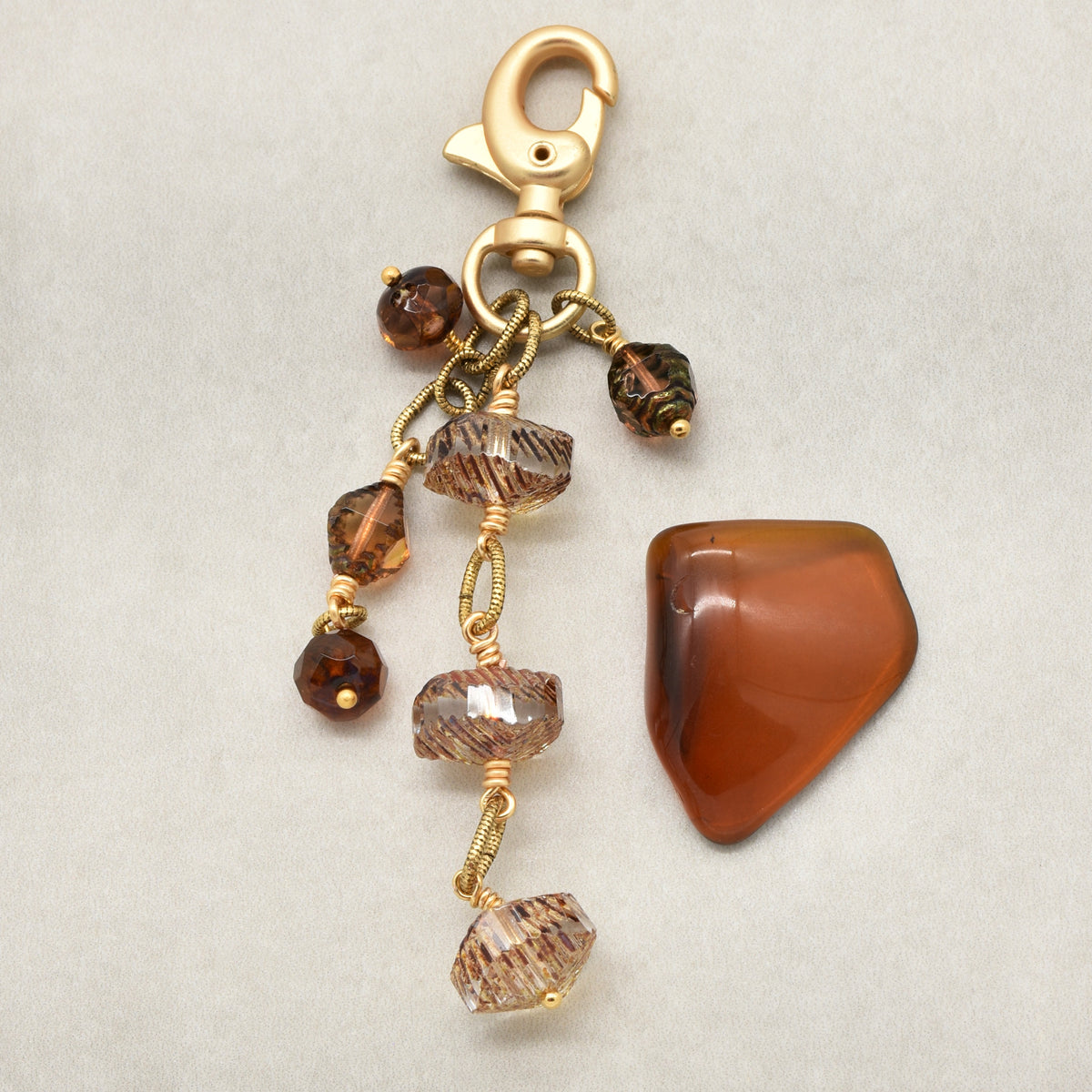 Smoky Reverie Handbag Charm featuring wire-wrapped etched Czech glass rondelles in smoky topaz with gold lobster claw, handmade by Ruby Acorn